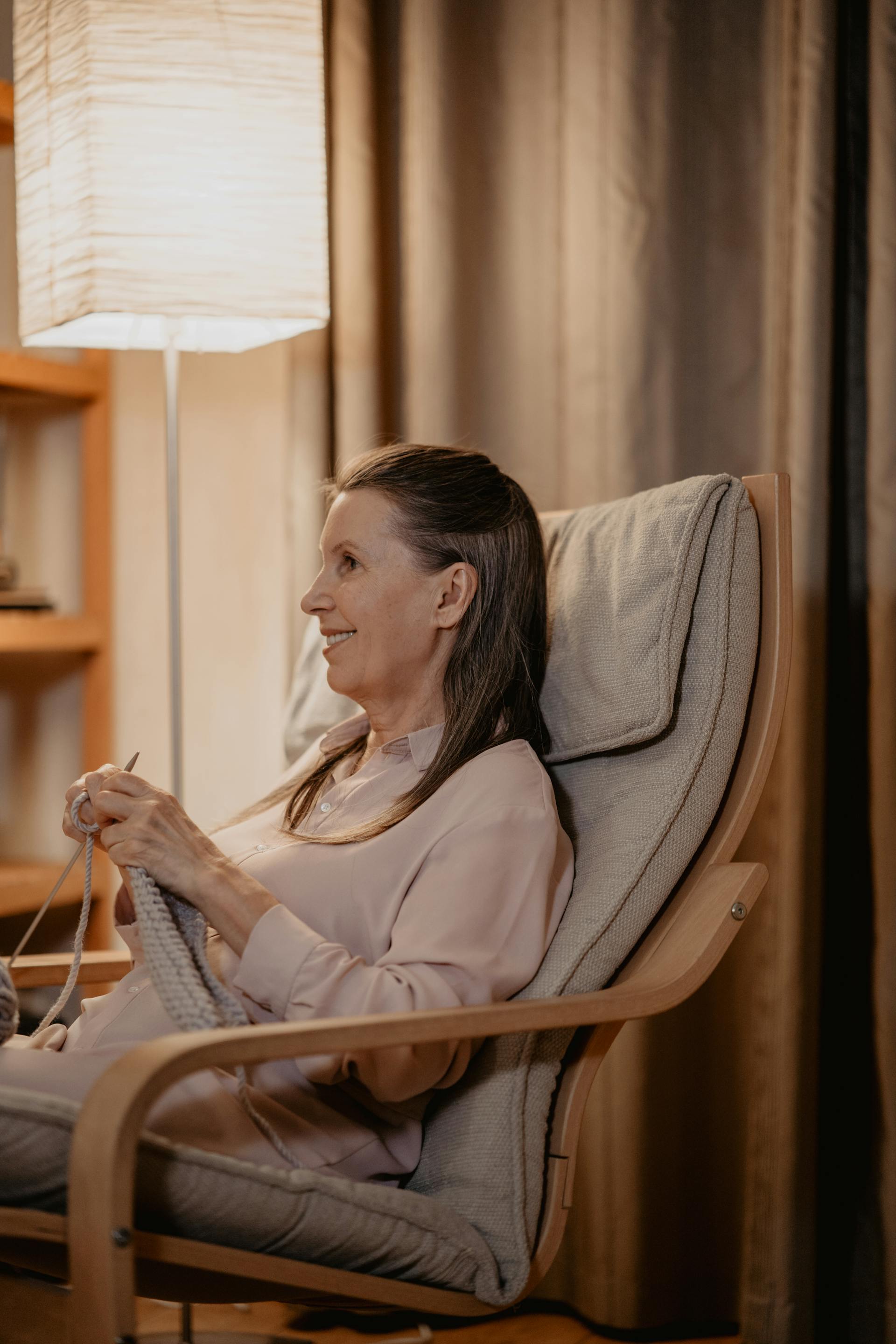 A senior woman sitting on a chair and knitting | Source: Pexels
