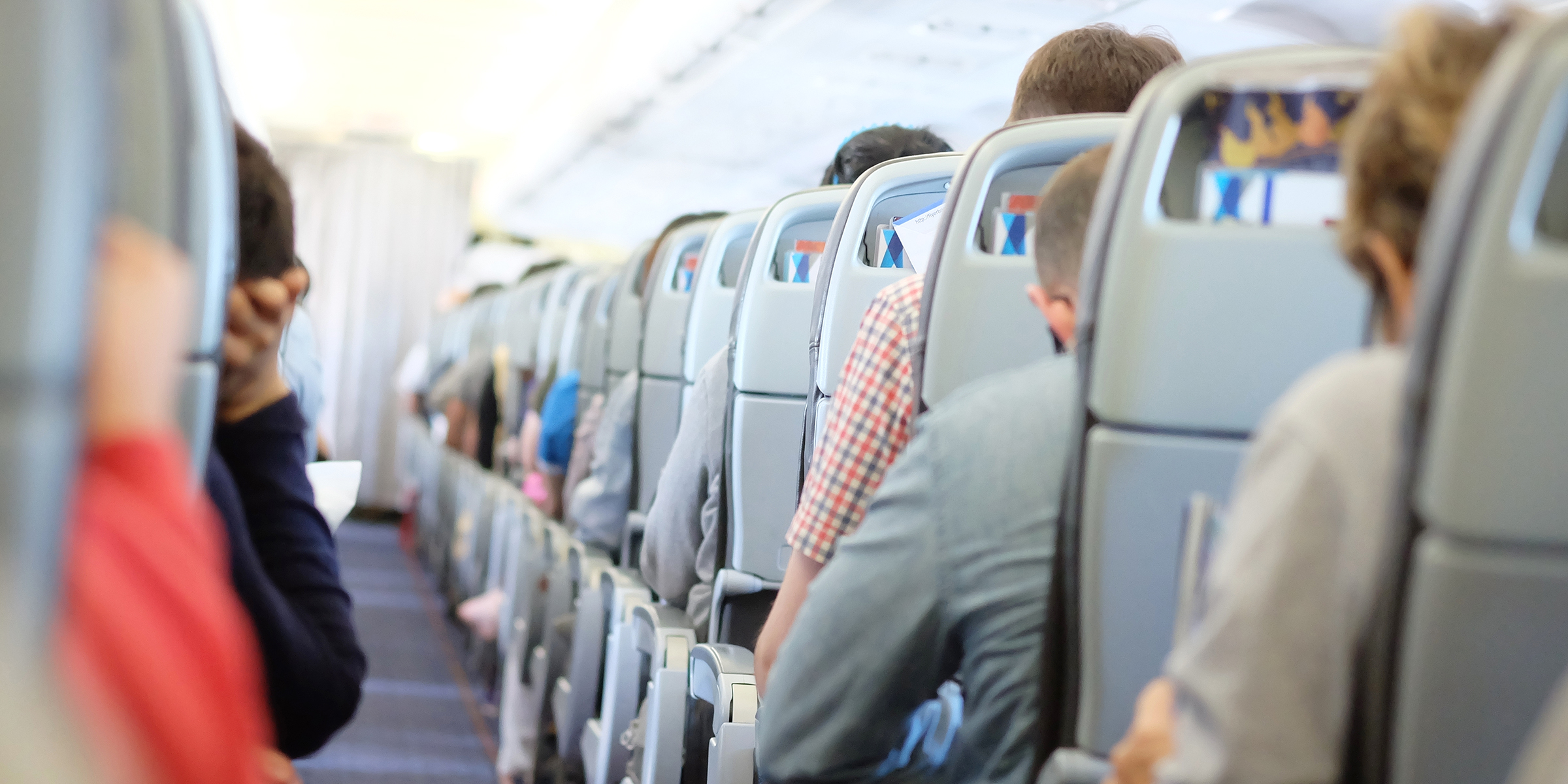 Passengers seated in economy class during a commercial flight | Source: Shutterstock