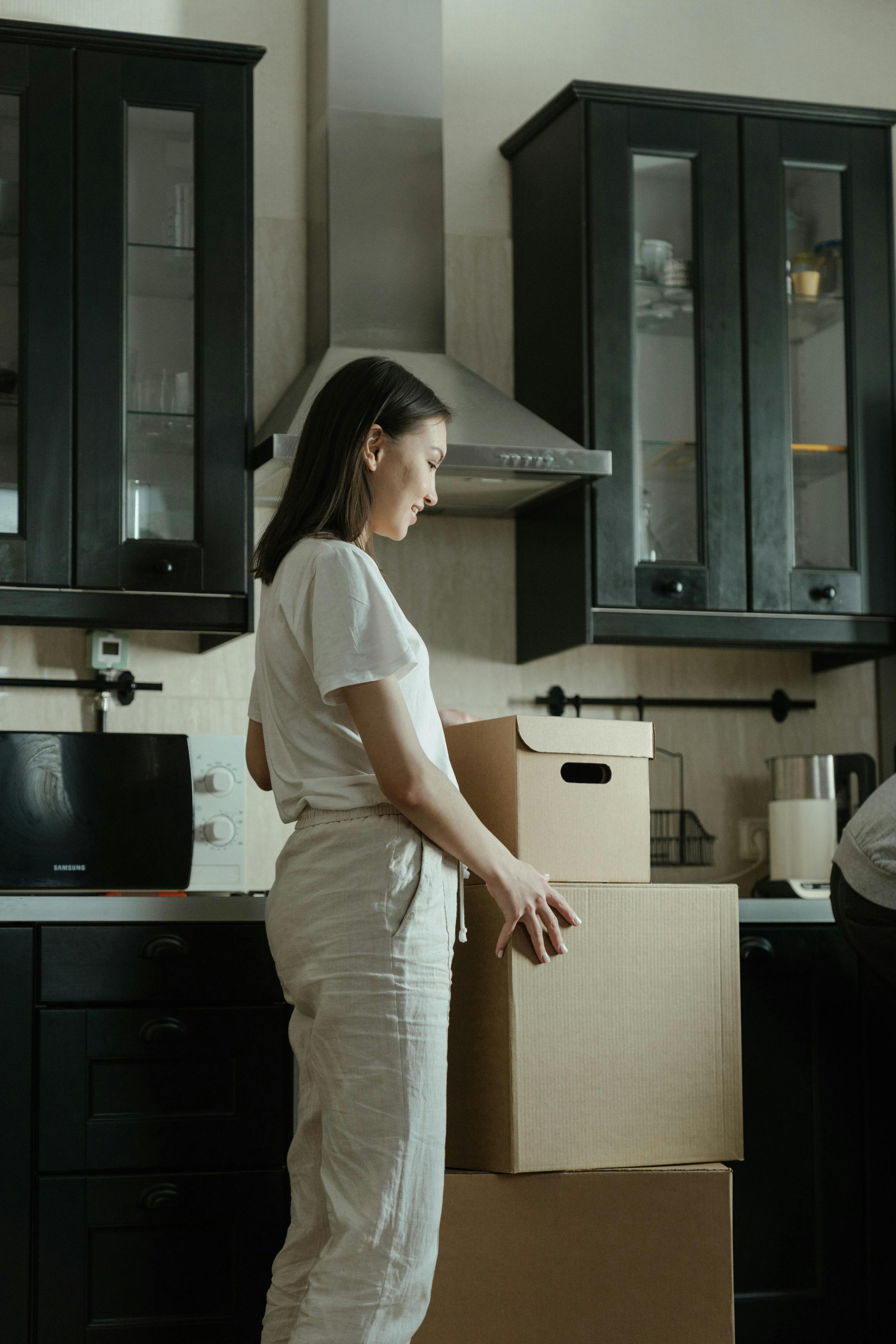 A happy girl with boxes | Source: Pexels