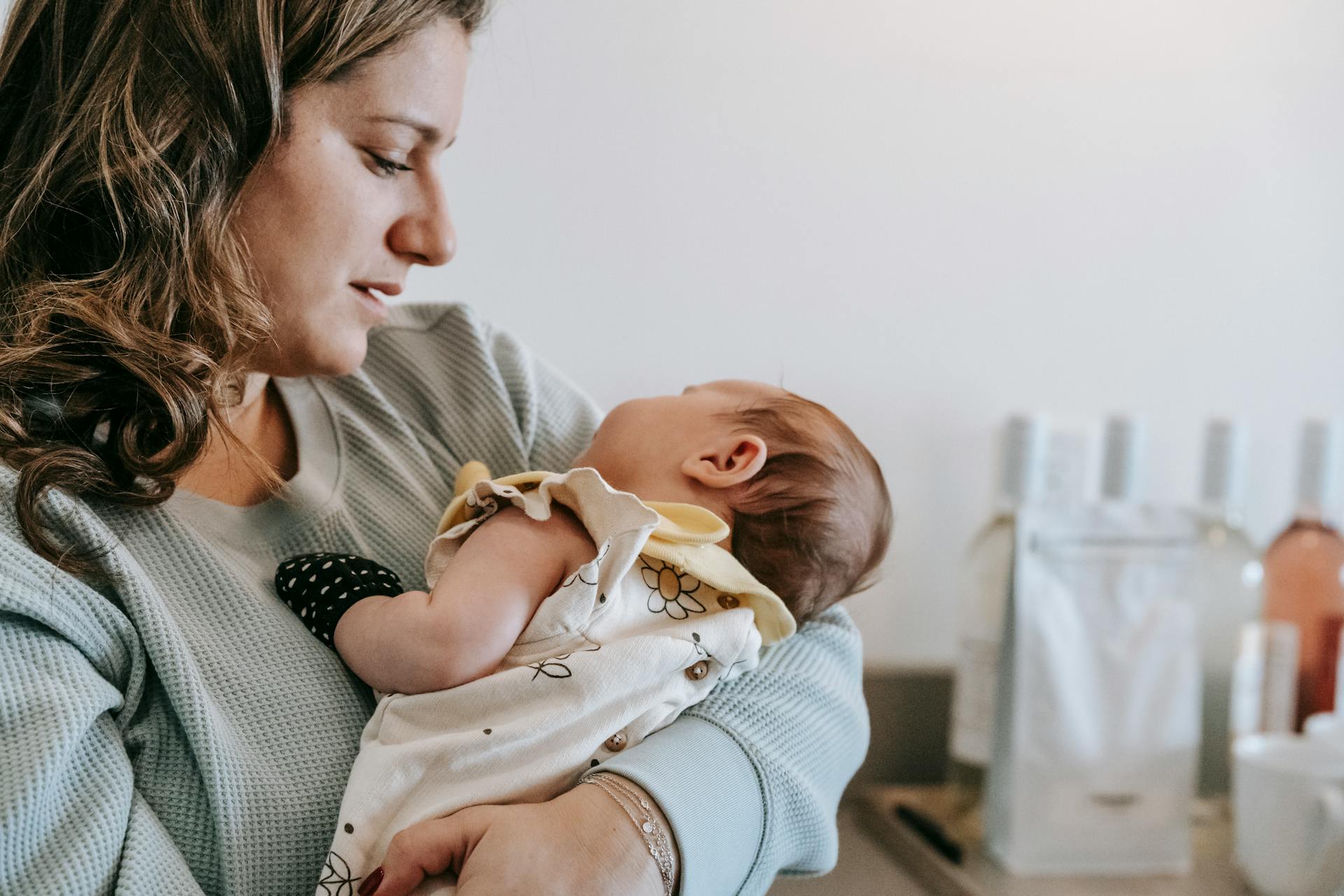 A depressed mother looking at her baby | Source: Pexels