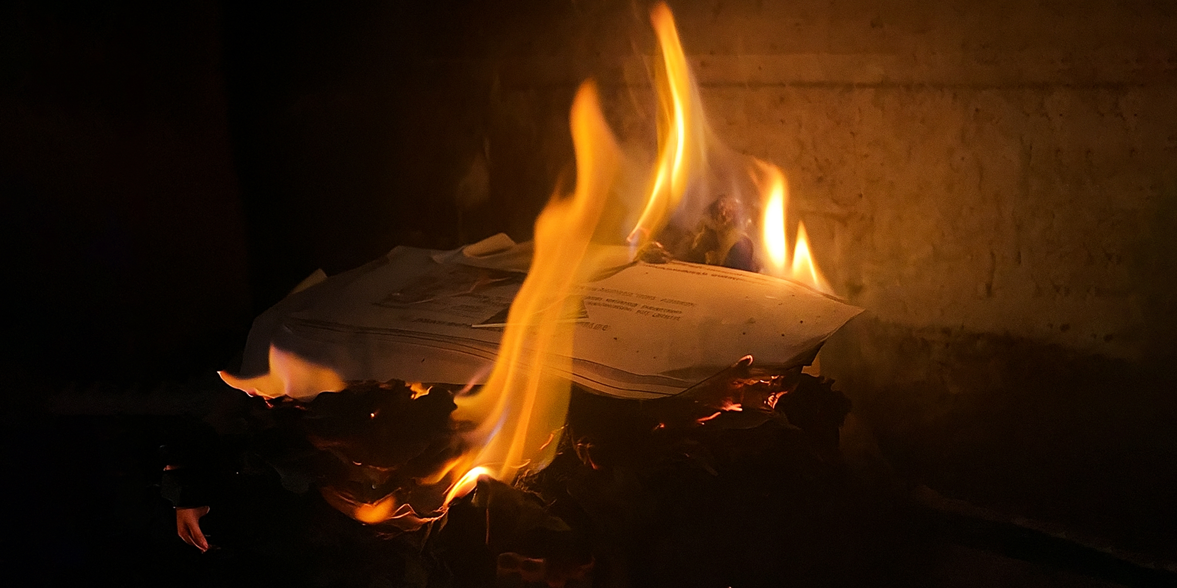 Documents burning in the fireplace | Source: Pexels