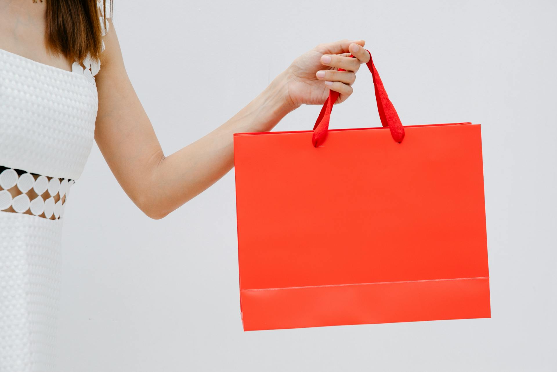 A woman taking a gift bag from someone | Source: Pexels