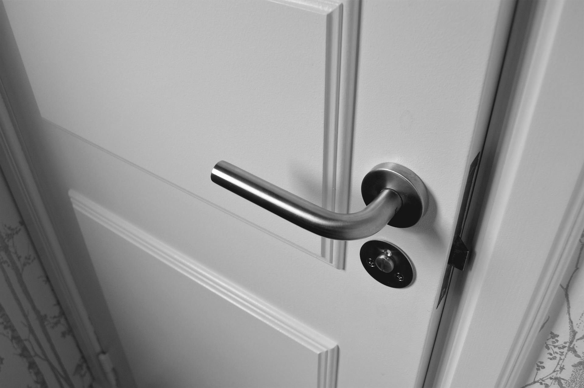 Grayscale shot of a door slammed shut | Source: Pexels