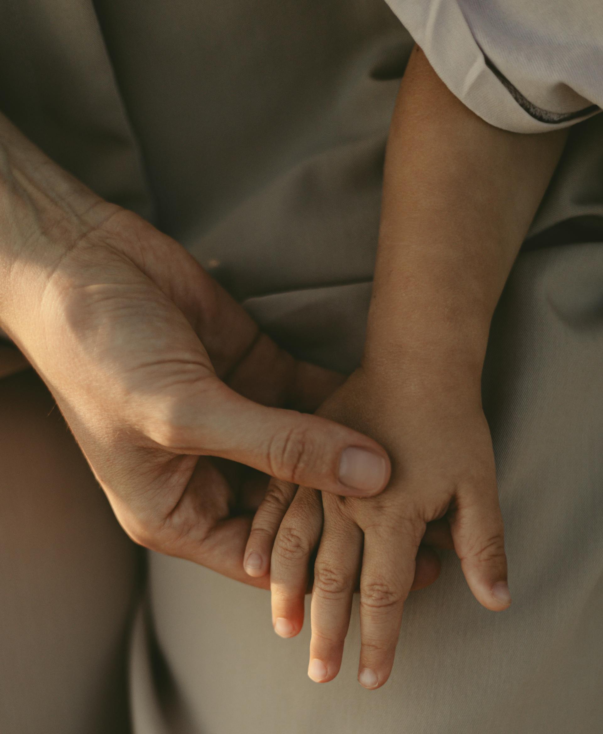 A woman holding her son's hand | Source: Pexels