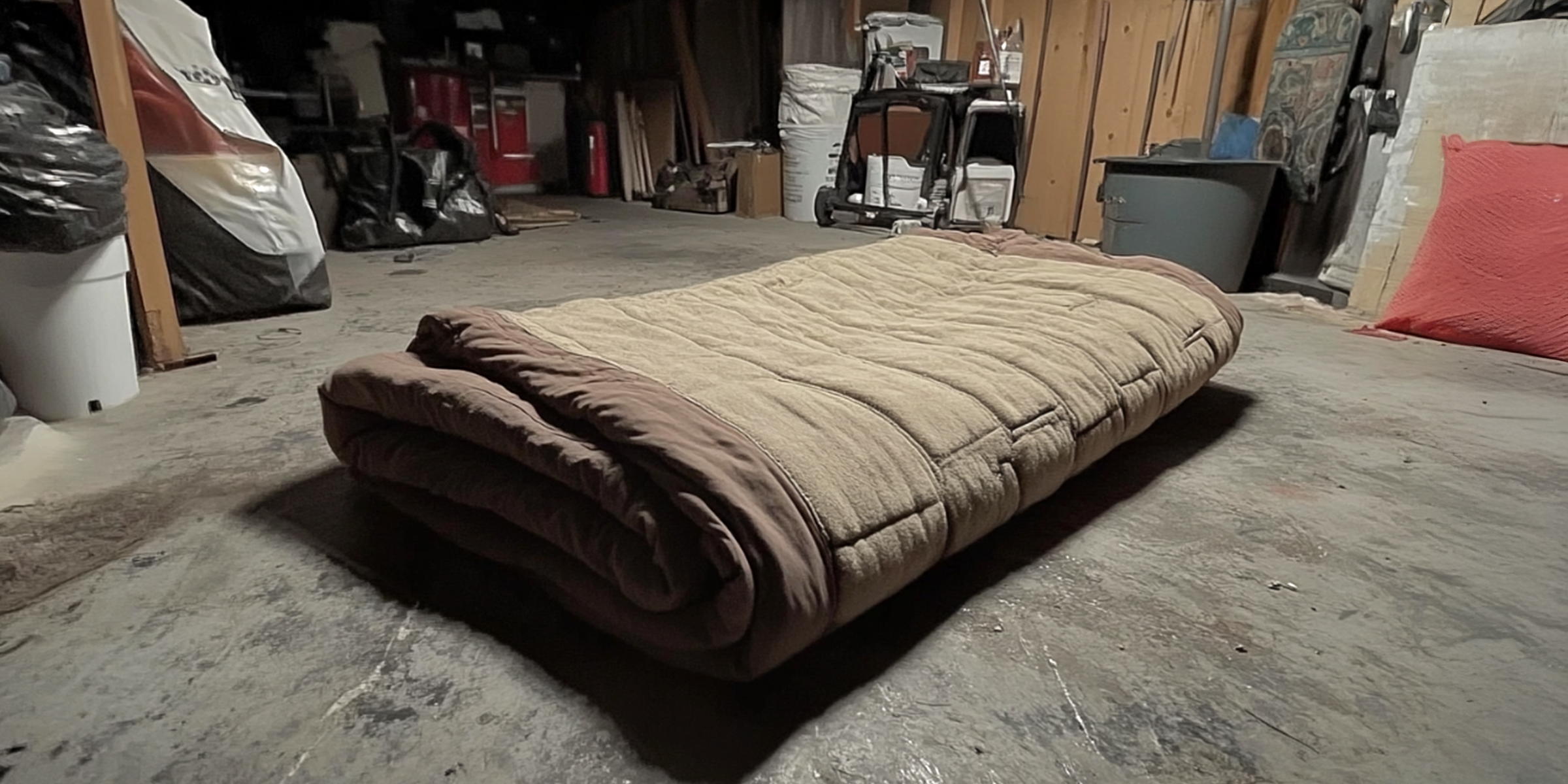 A folded duvet in a garage | Source: AmoMama