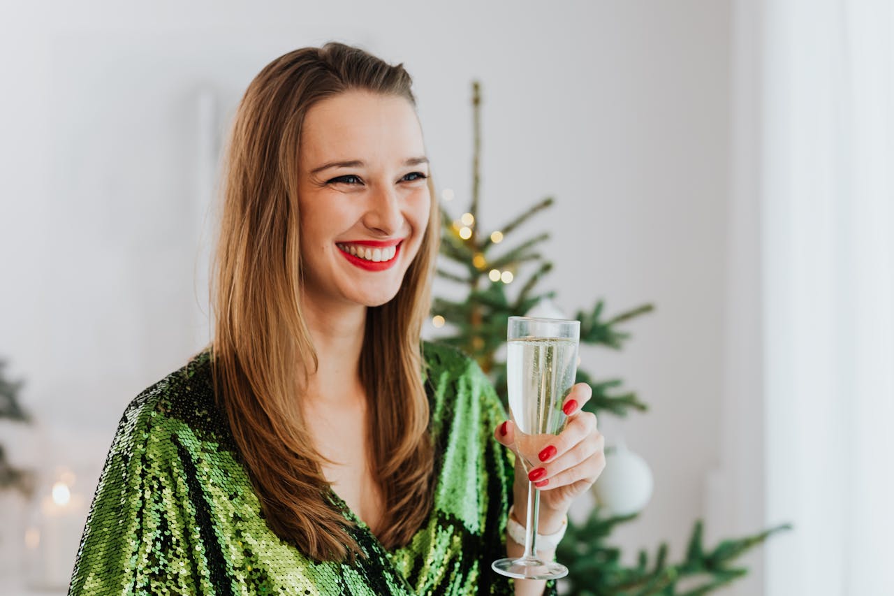 A delighted woman raising a toast | Source: Pexels