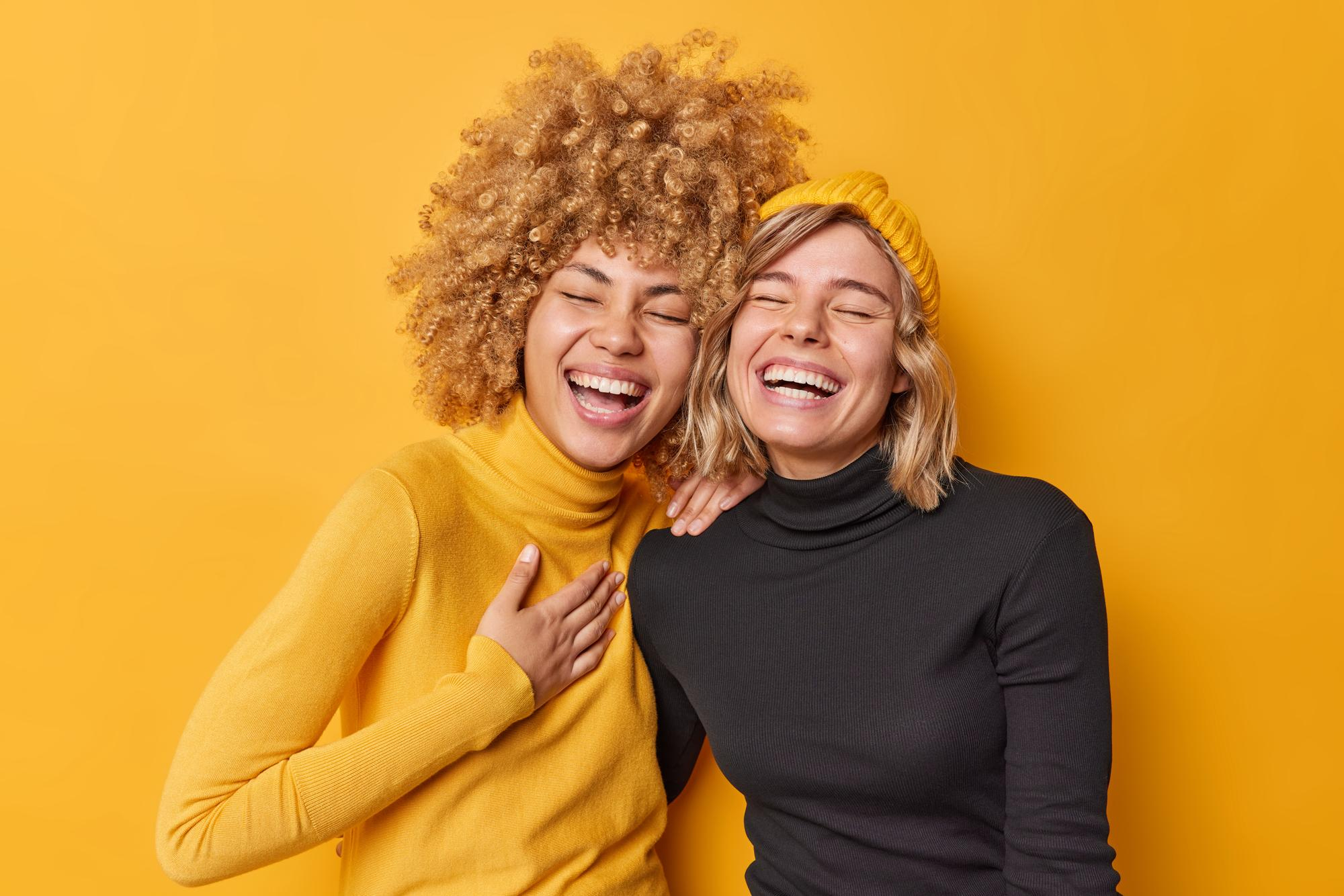 Two women laughing | Source: Freepik