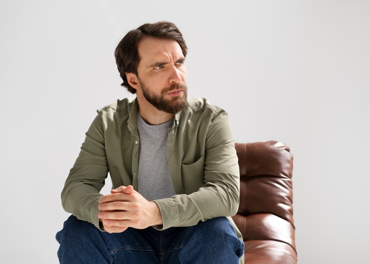 A man sitting on a chair | Source: Freepik