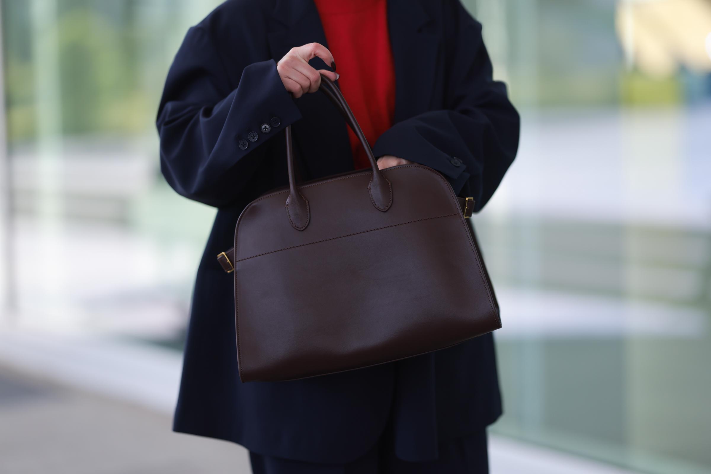 Maria Barteczko seen wearing The Row burgundy red leather Margaux top handle bag, on April 23, 2024 in Cologne, Germany. | Source: Getty Images