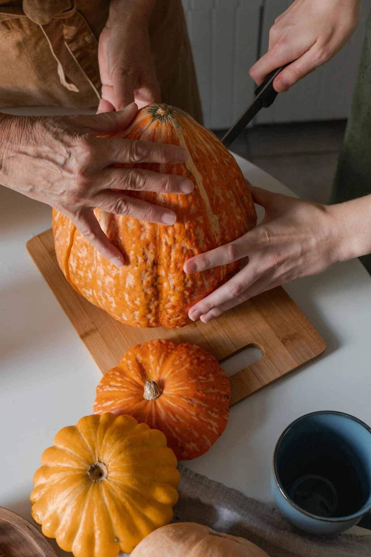 Two women cutting a pumpkin | Source: Pexels