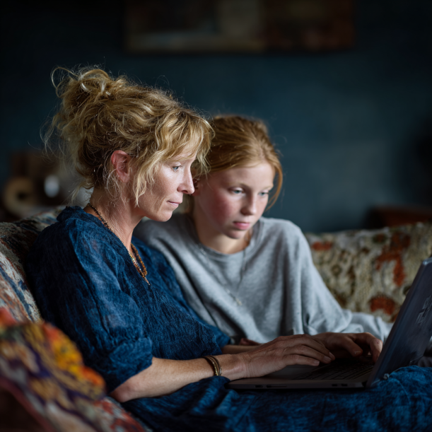 Mother and daughter working on a laptop | Source: Midjourney