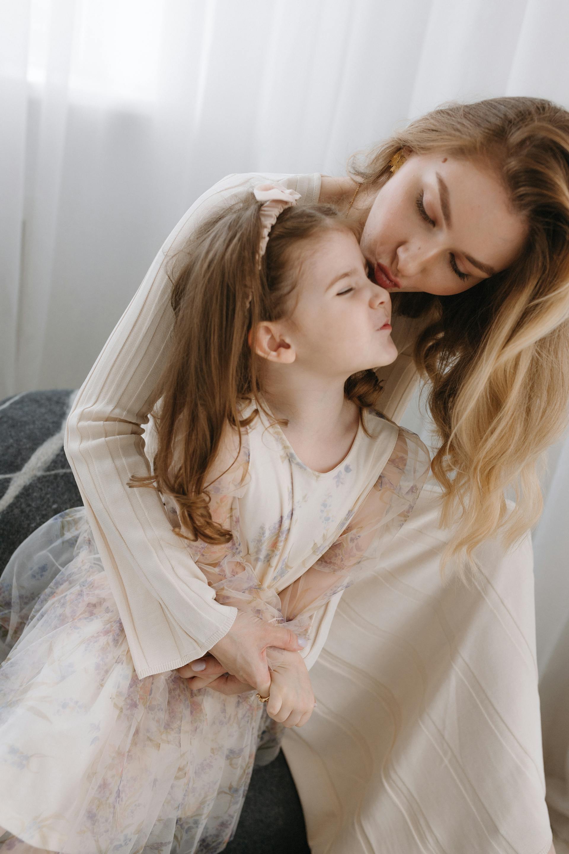 A woman hugging her little girl | Source: Pexels