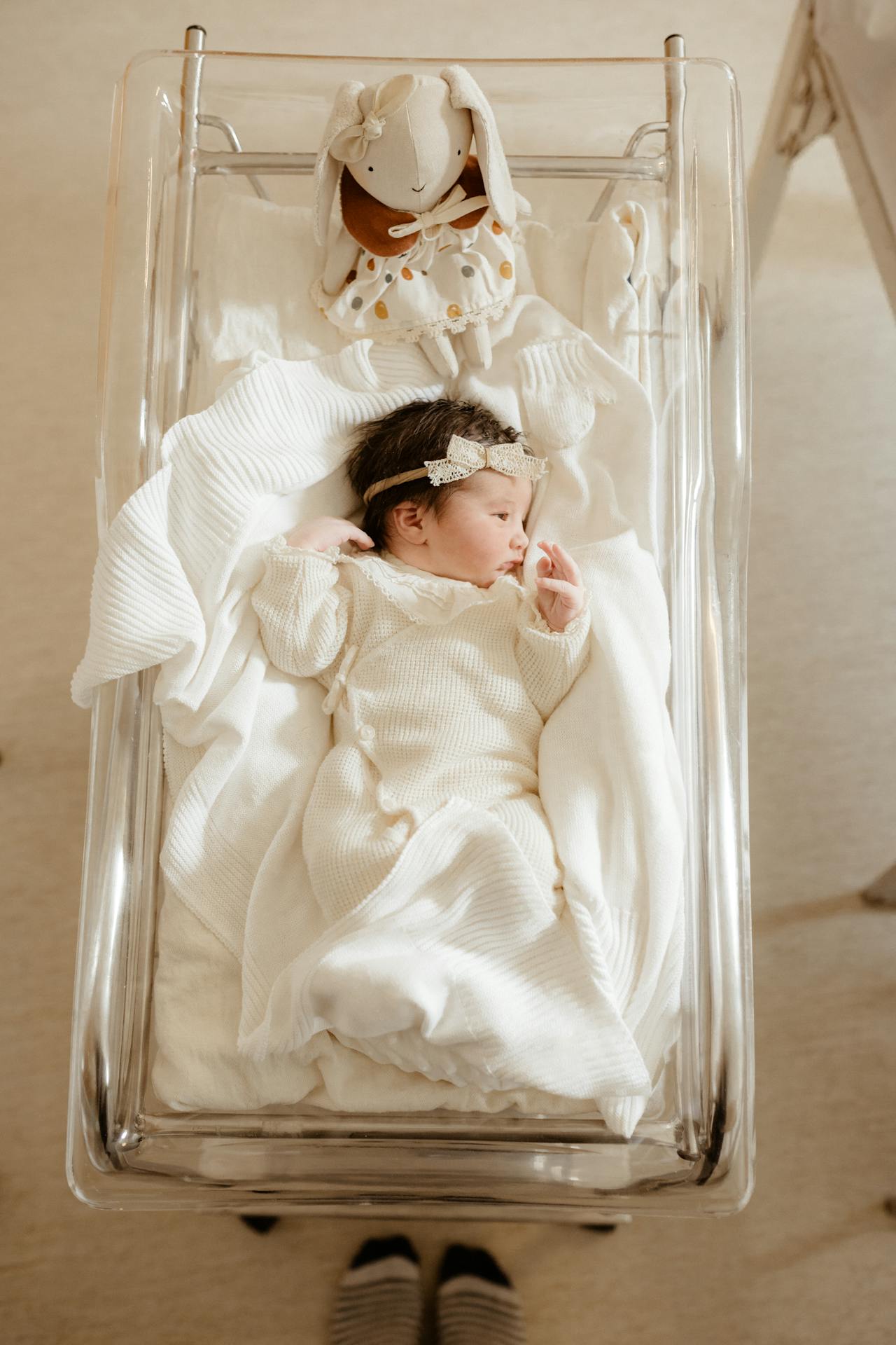 An adorable baby girl lying in her crib | Source: Pexels