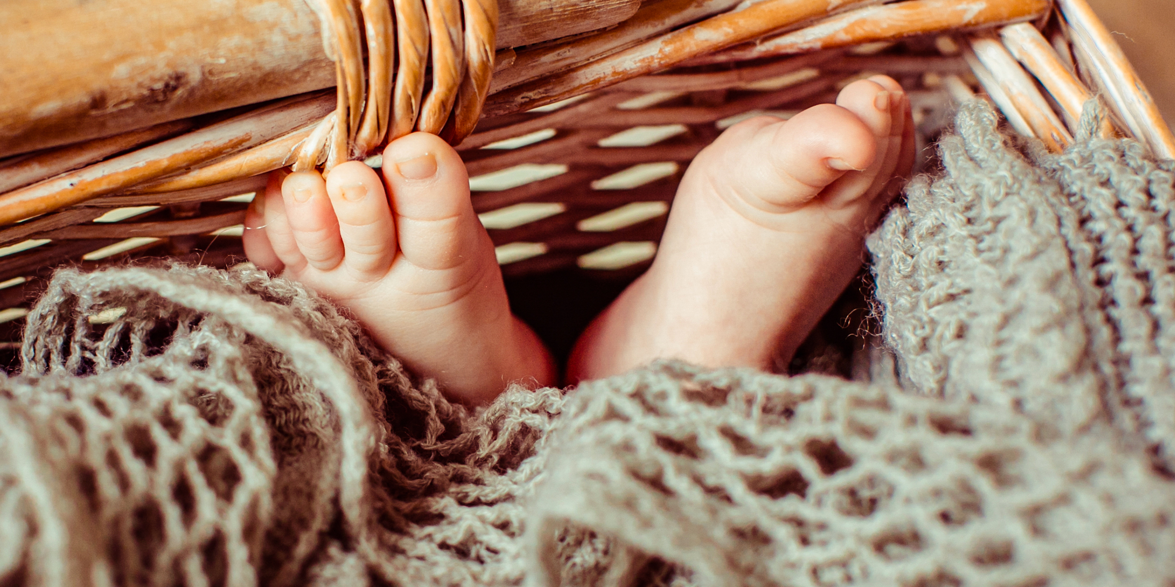 Feet of a baby lying in a basket | Source: Shutterstock