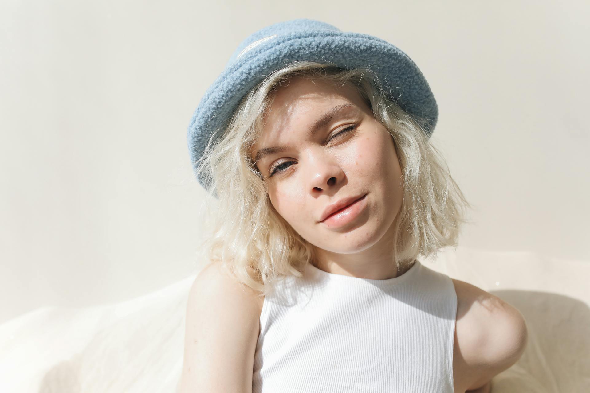 A teen girl winking at someone | Source: Pexels