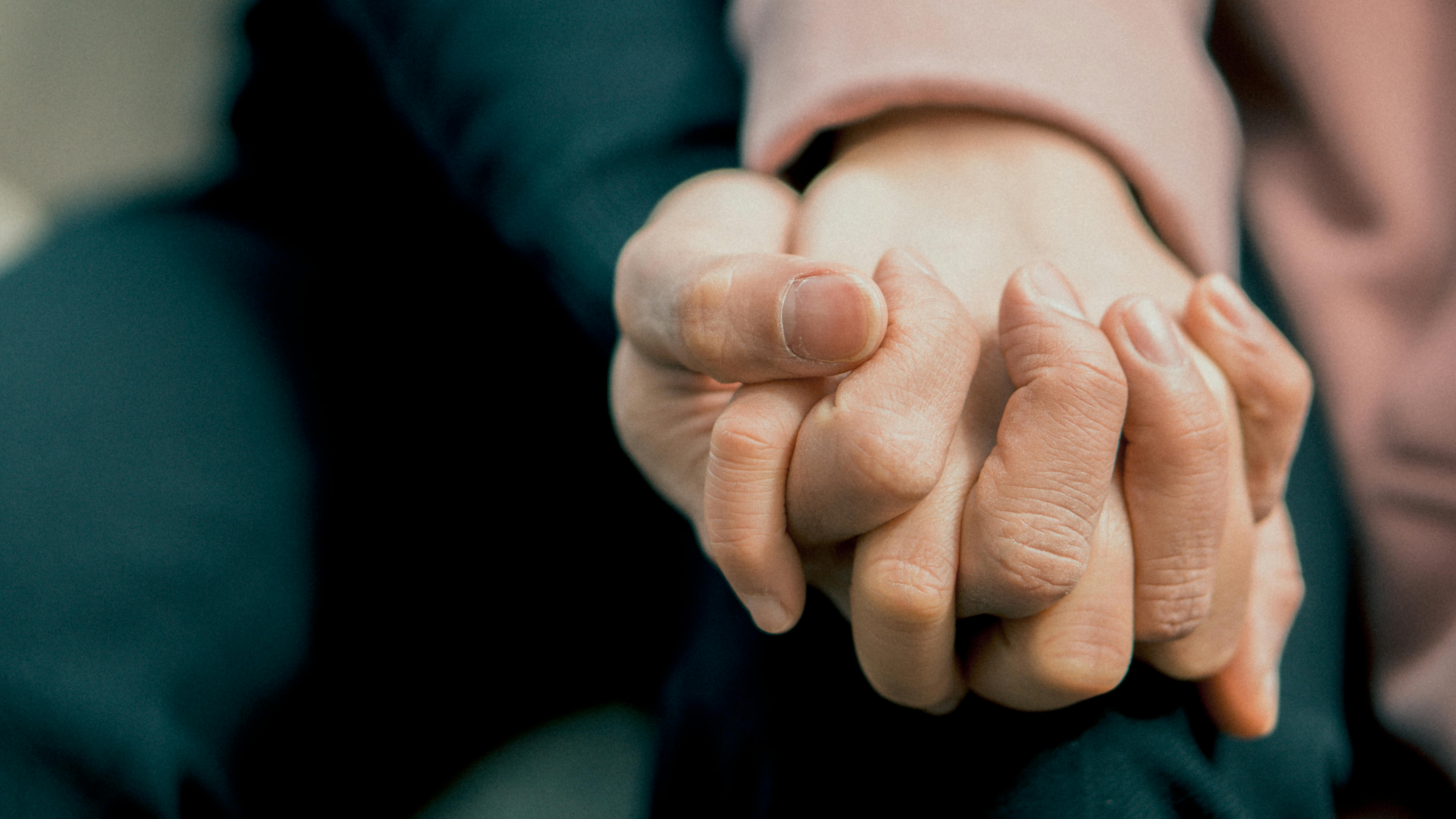 A couple holding hands | Source: Pexels