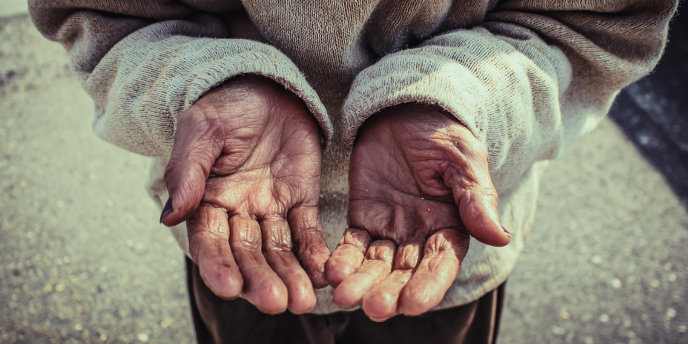 A homeless person holding out their hands | Source: The Celebritist