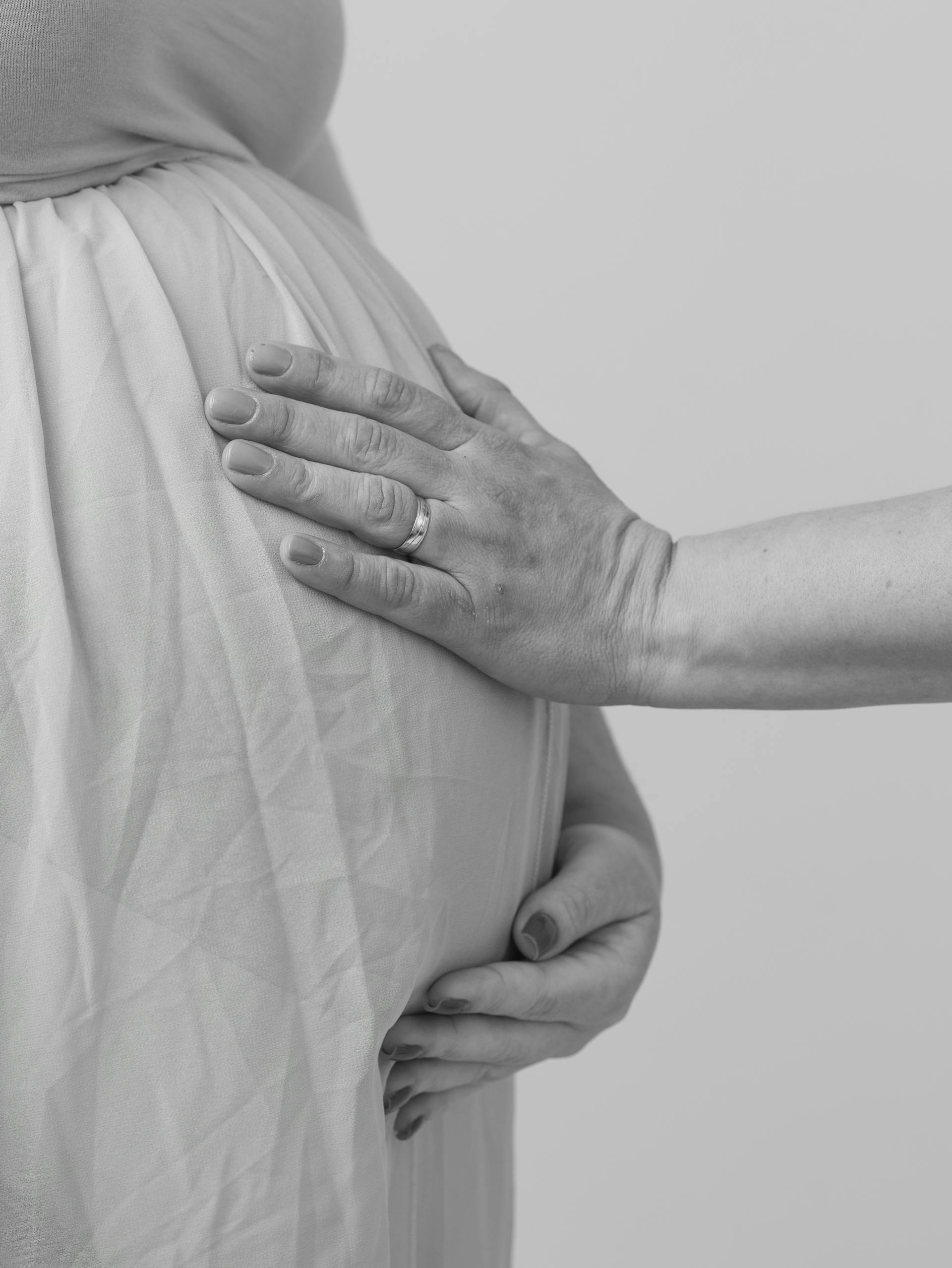 A husband touching his wife's pregnant belly | Source: Pexels