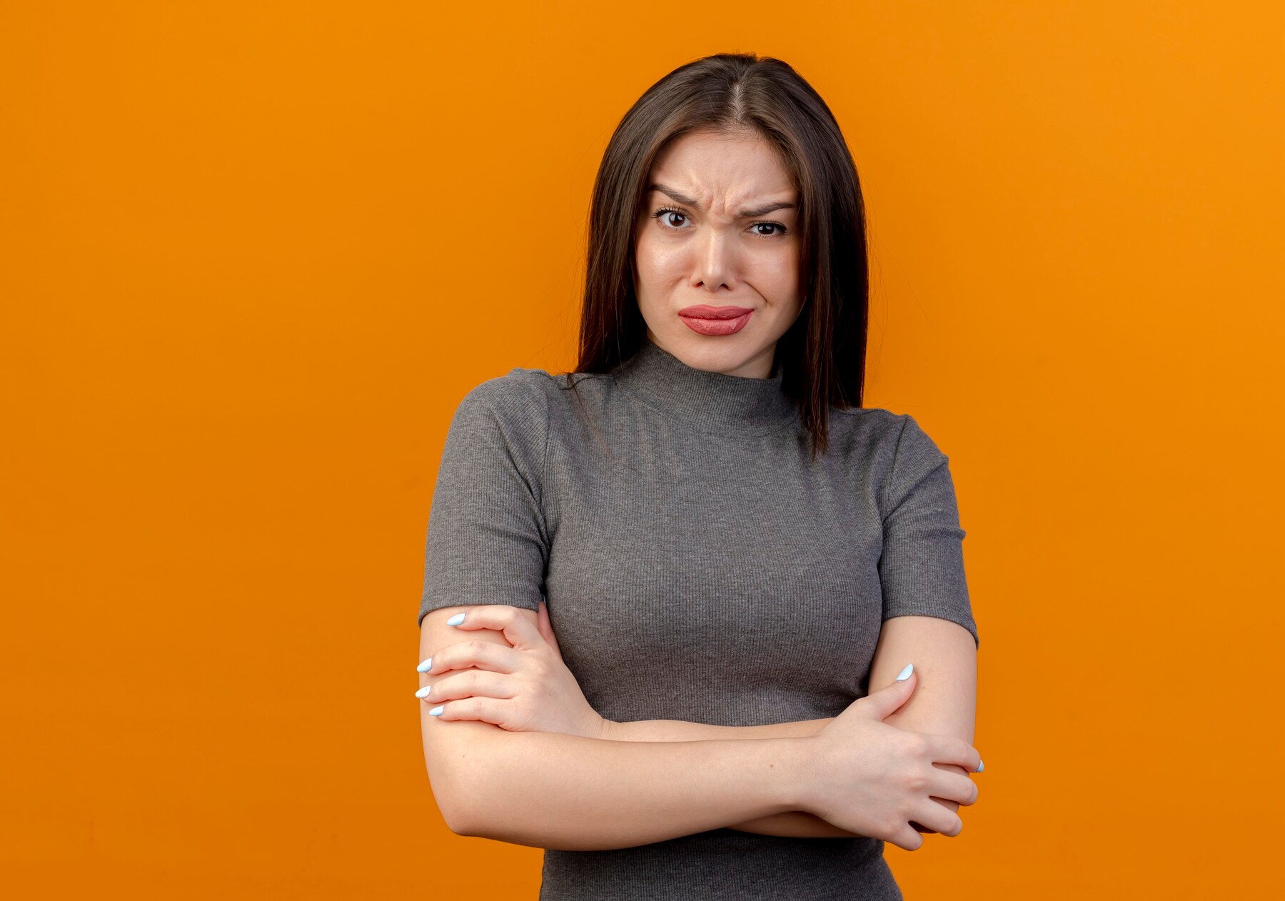 An offended woman with her arms crossed | Source: Freepik