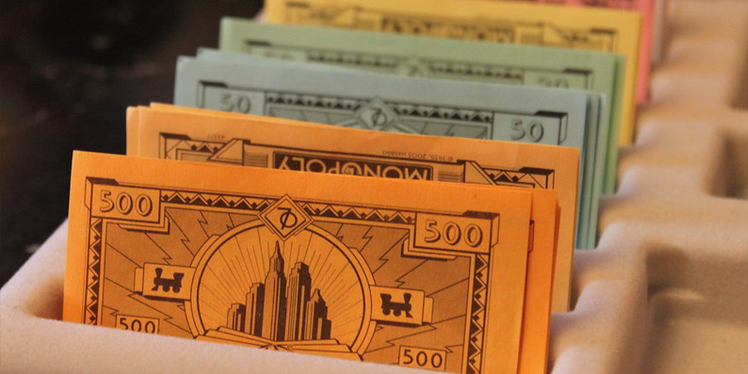 Stacks of play money | Source: Flickr