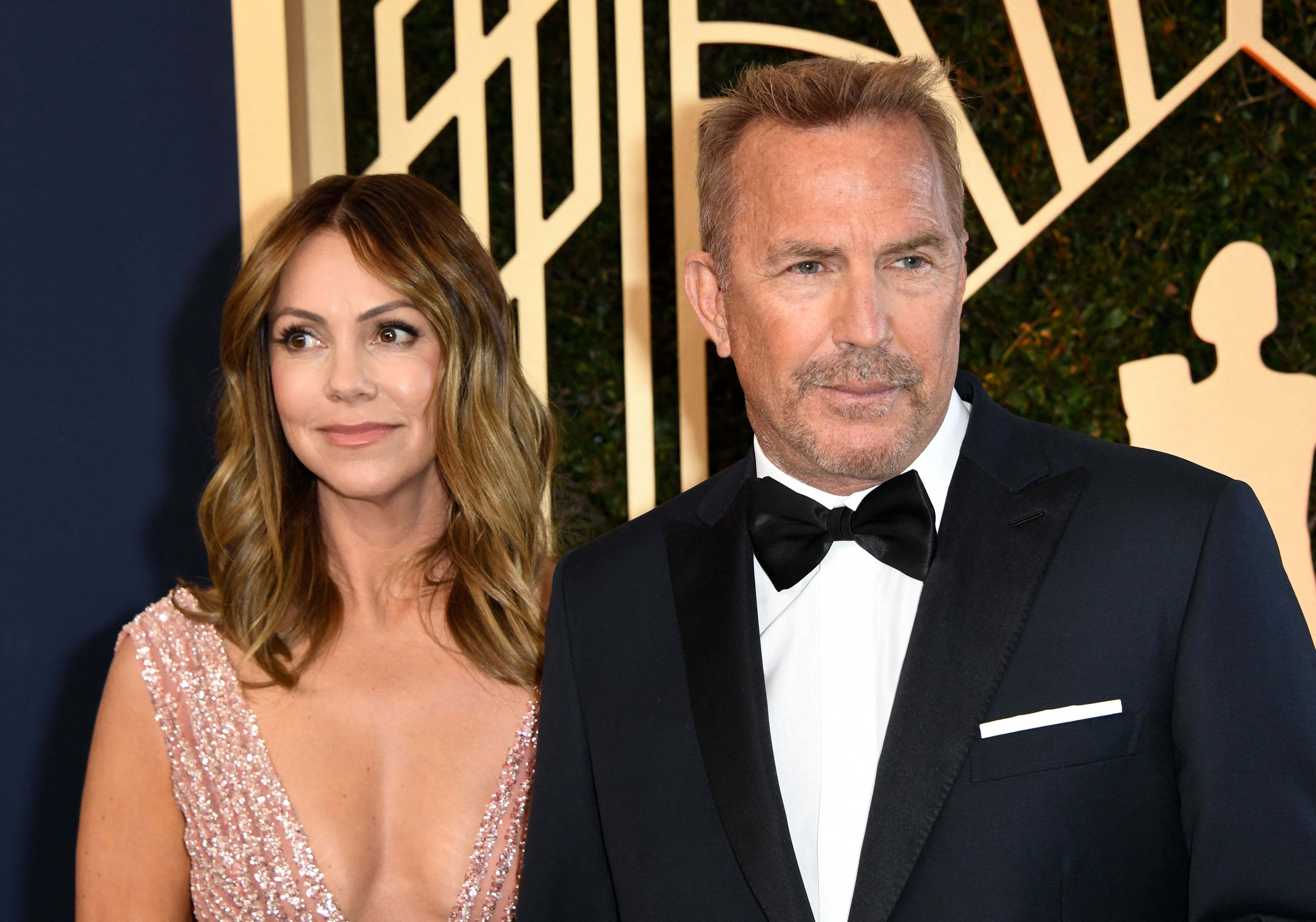Kevin Costner and Christine Baumgartner arrive for the 28th Annual Screen Actors Guild (SAG) Awards in Santa Monica, California, on February 27, 2022. | Source: Getty Images