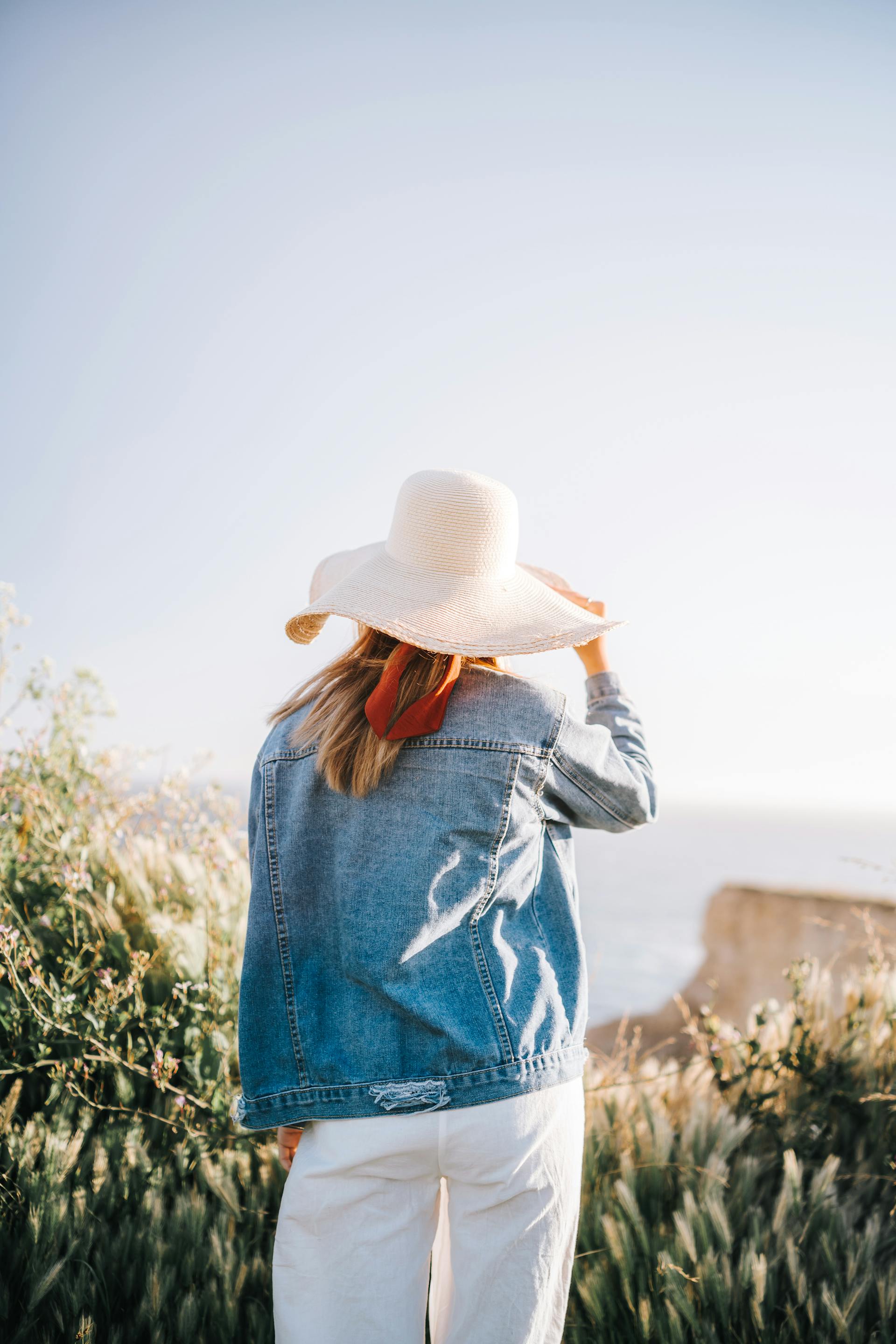 A back-view of a woman standing outdoors | Source: Pexels