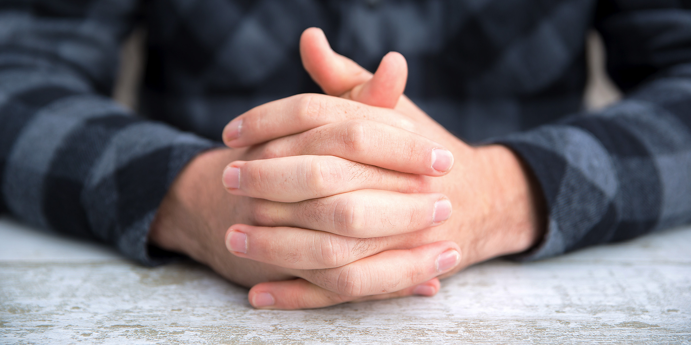 A man sitting with folded arms | Source: Freepik