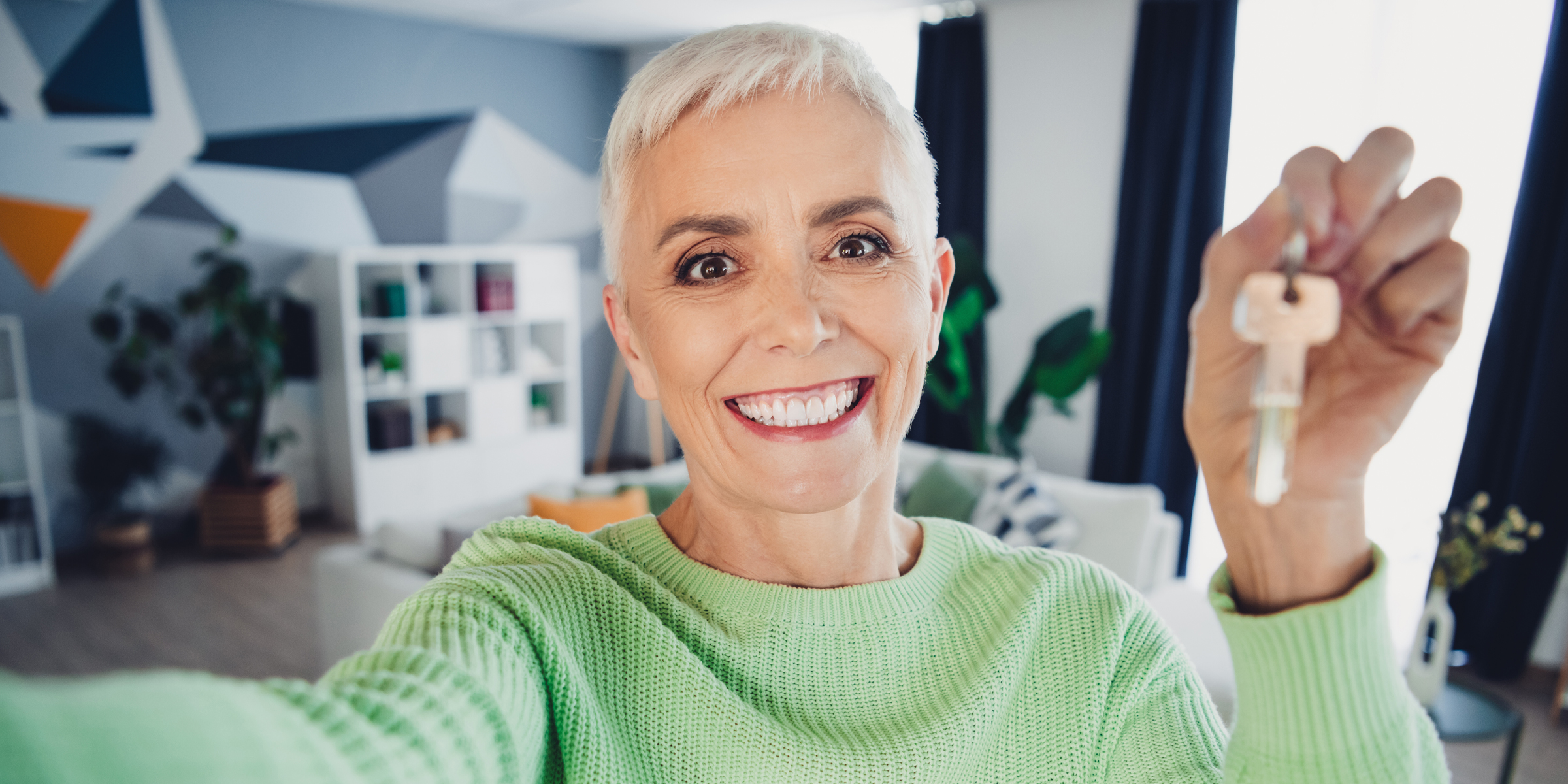 A woman holding a key | Source: Shutterstock