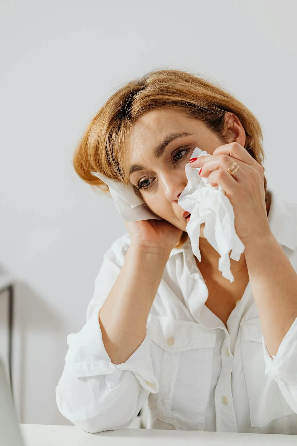 A crying woman wiping her eyes | Source: Pexels