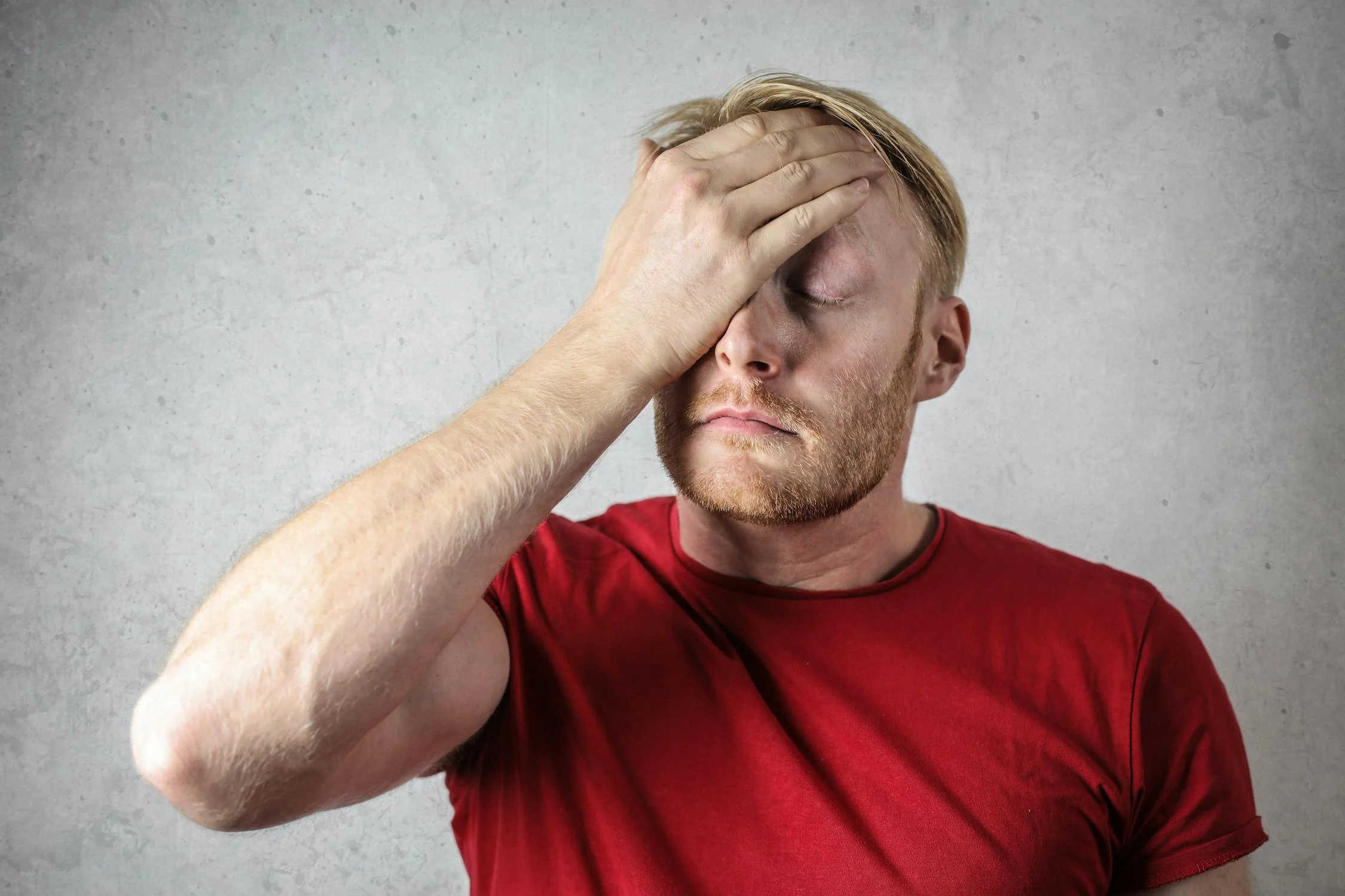 Un hombre cansado secándose la cara ⏐ Fuente: Pexels