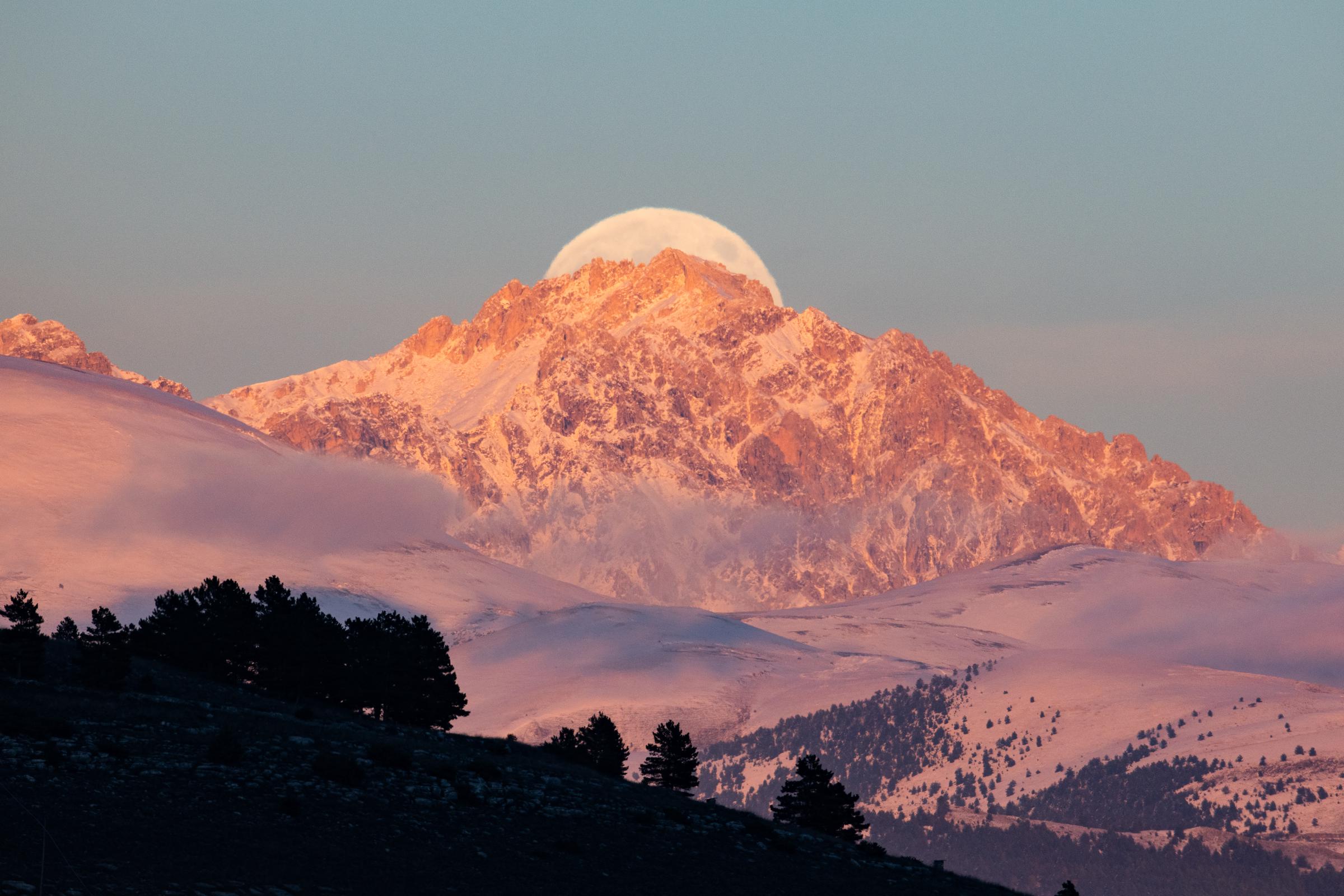 Beaver full moon rising behind Monte Prena peaks is seen from L'Aquila, Italy, on November 15, 2024 | Source: Getty Images