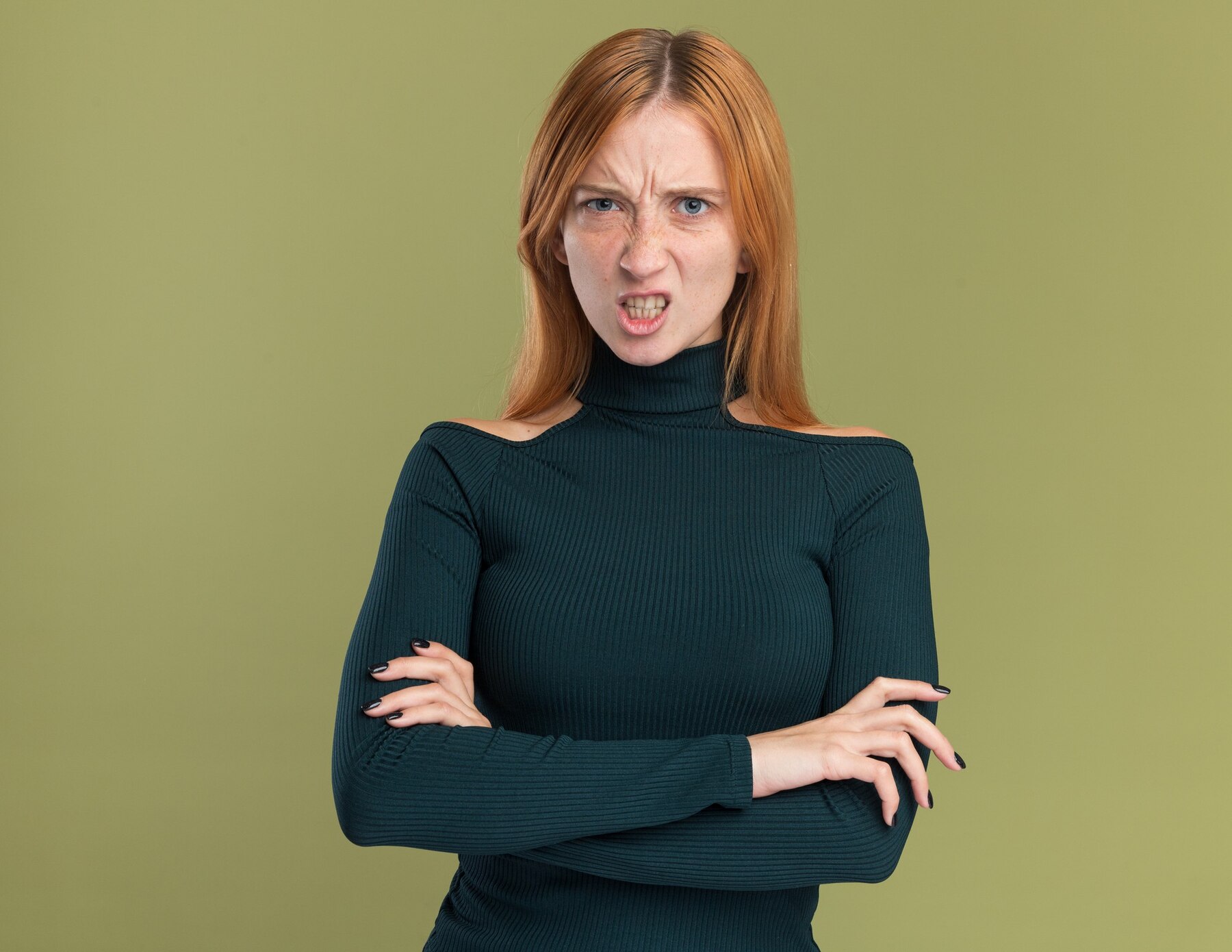 A disgusted woman in a green sweater | Source: Freepik