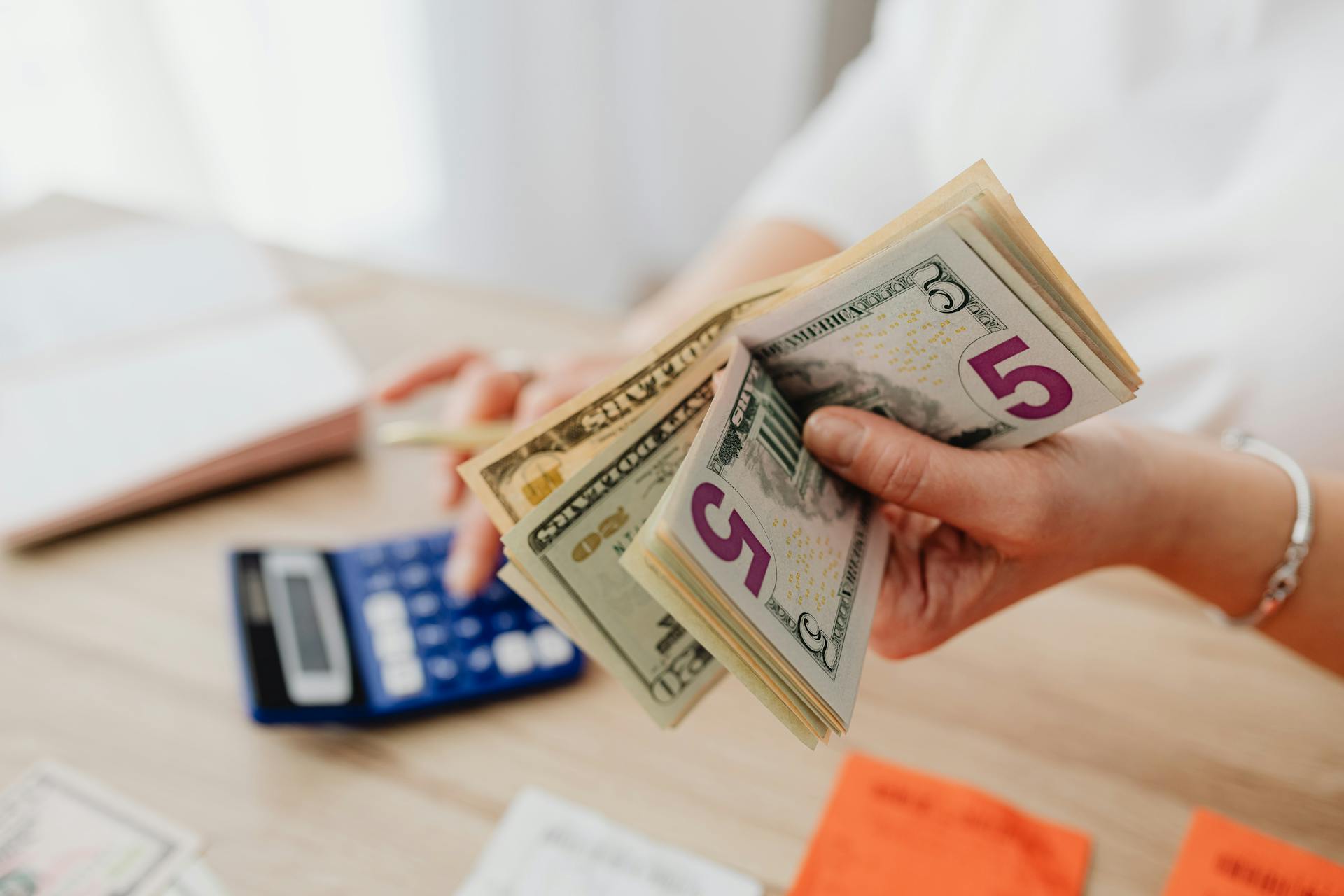 A woman holding money | Source: Pexels