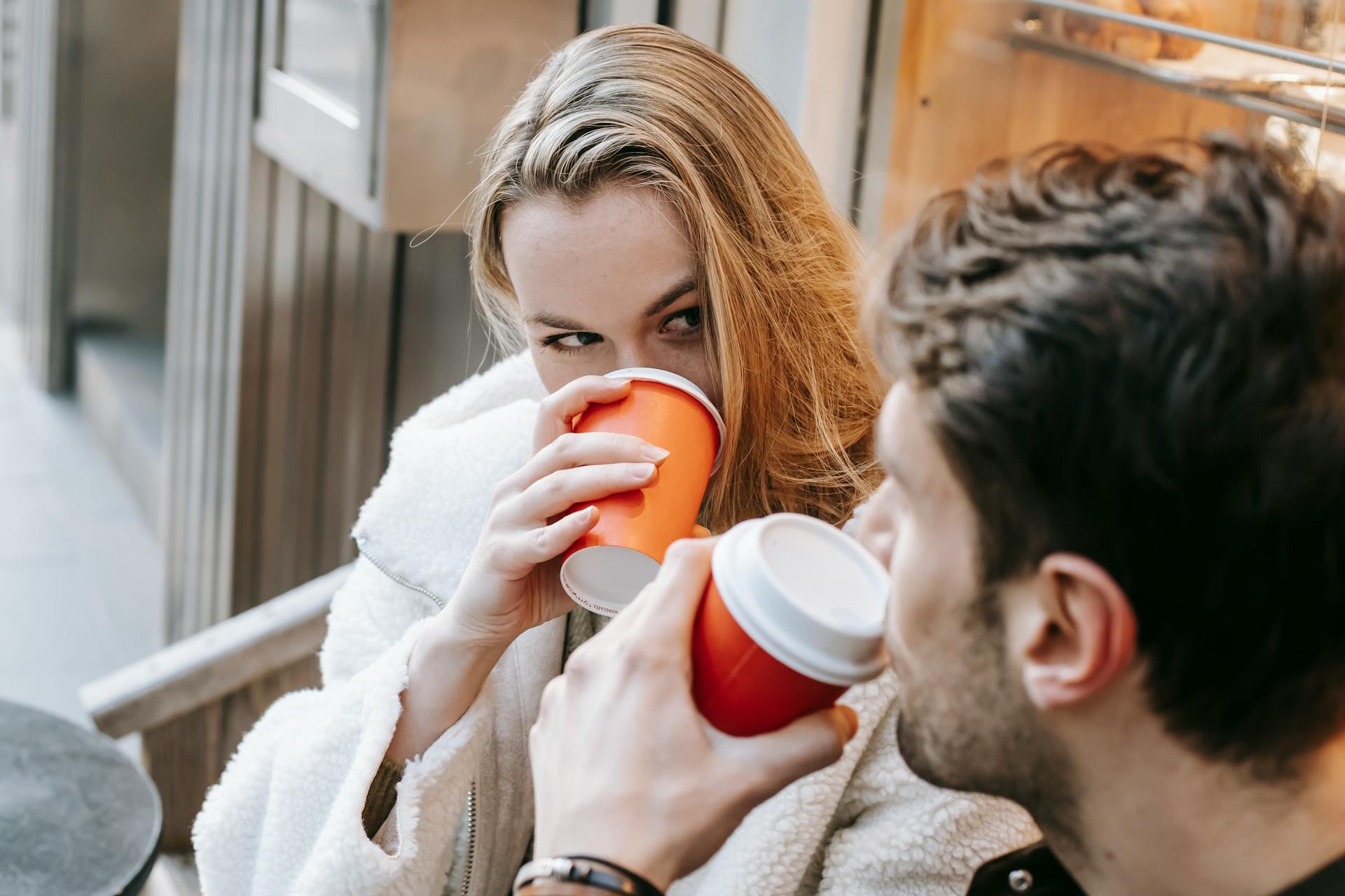 A romantic young couple looking at each other in a coffee shop | Source: Pexels