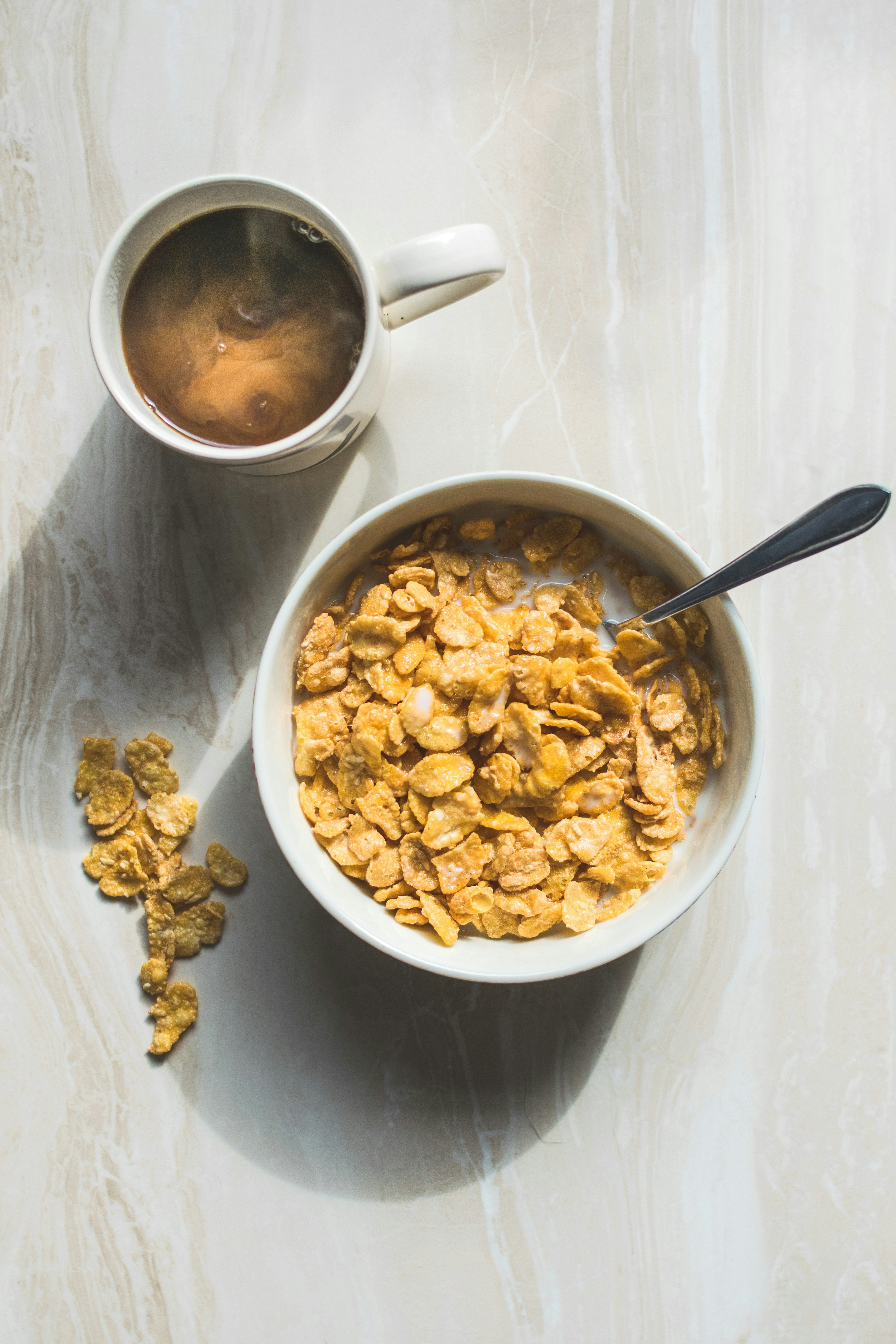A bowl of cereal and a cup of coffee | Source: Unsplash