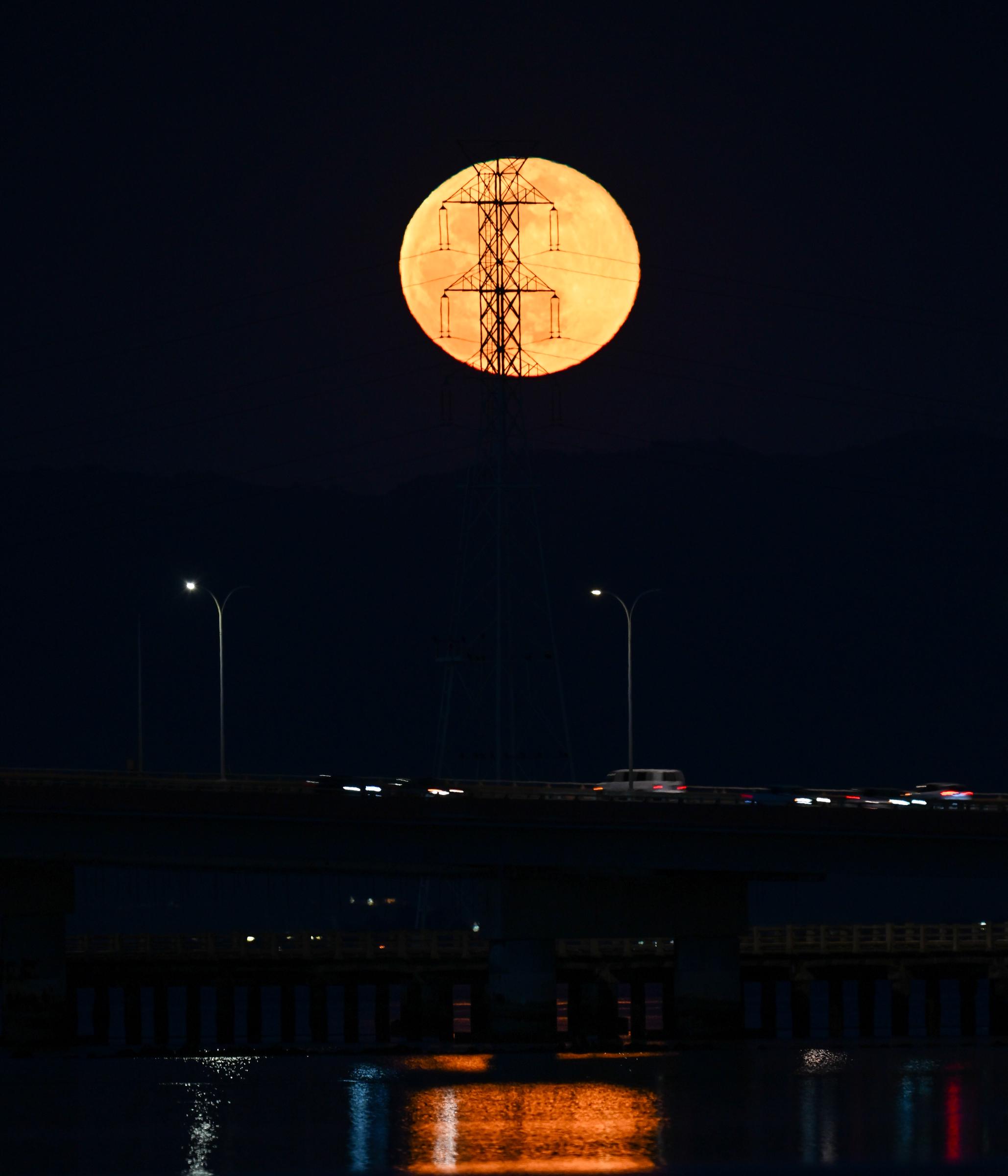 Full Snow Moon rises over San Mateo Bridge of San Francisco Bay in San Mateo, California on February 24, 2024 | Source: Getty Images