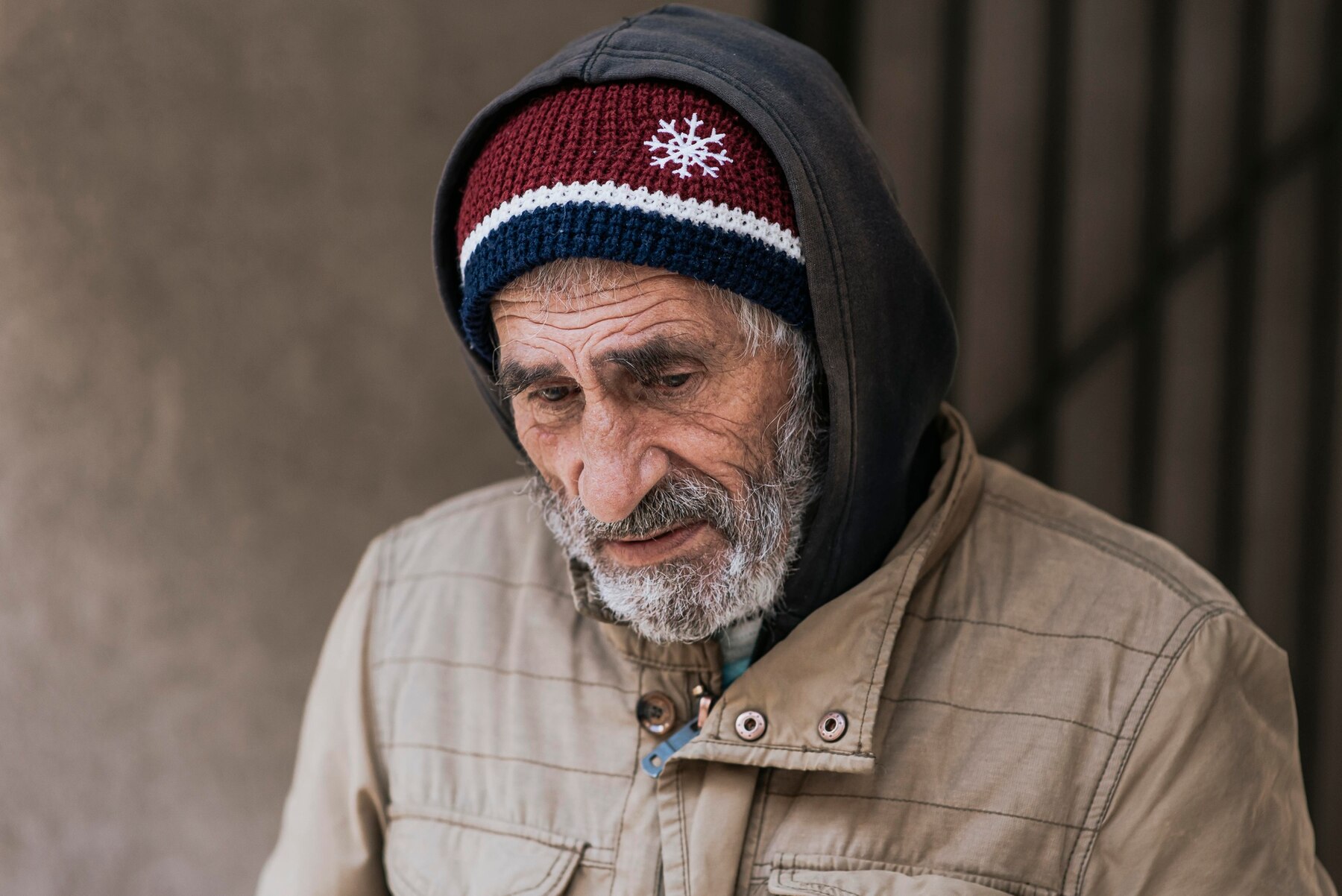 A homeless man looking down | Source: Freepik