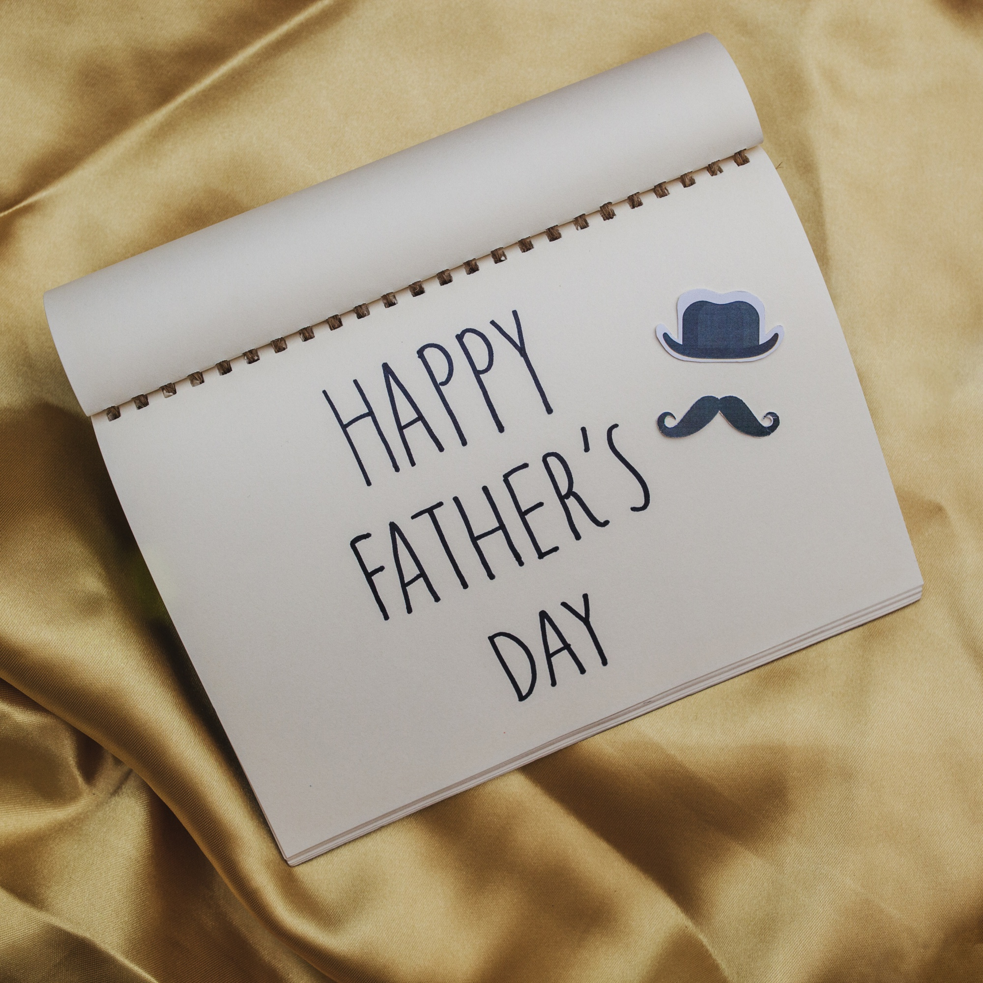 "Happy Father's Day" written on a notebook | Source: Freepik
