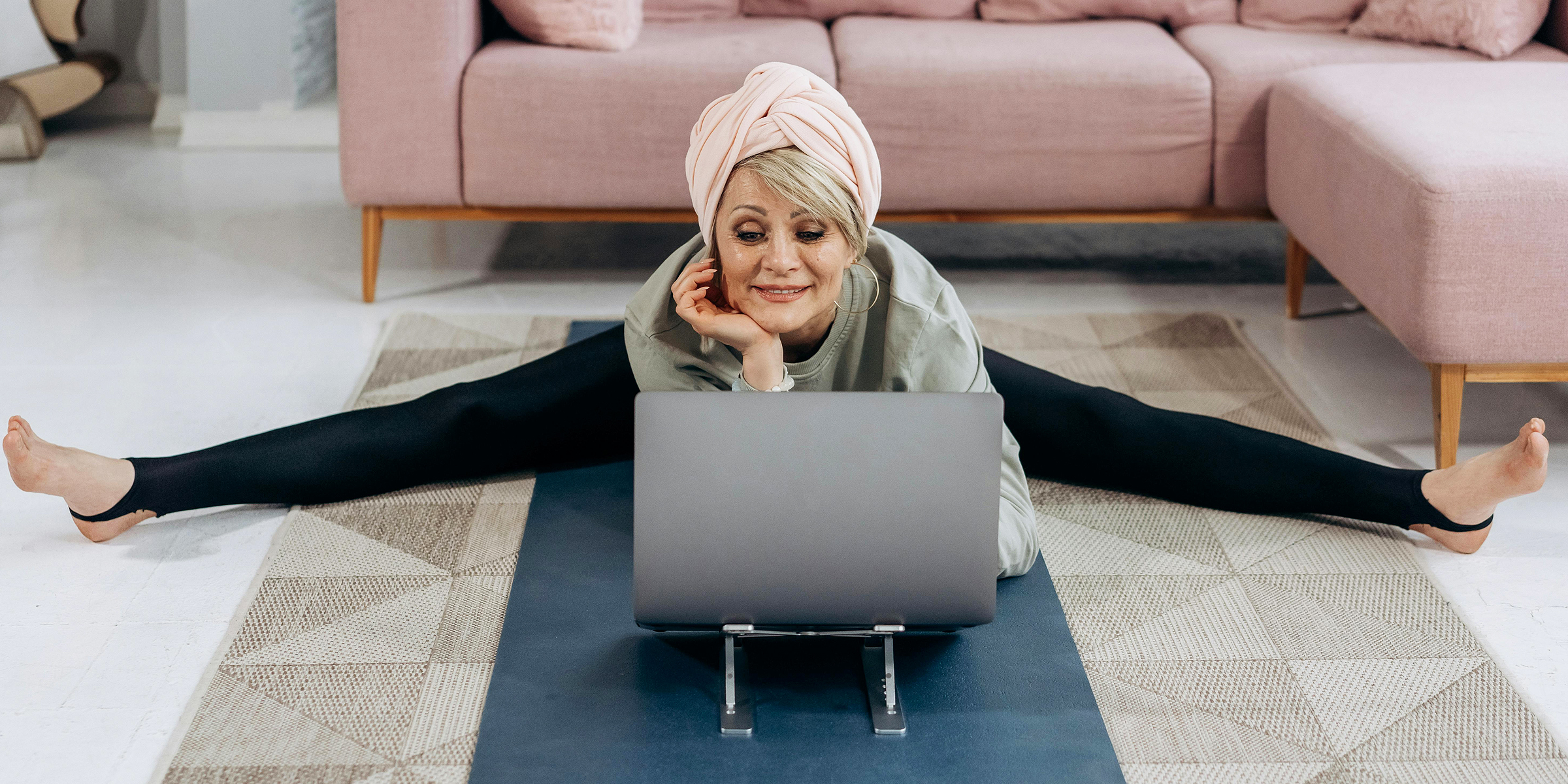 Elderly woman doing sports at her laptop | Source: Pexels