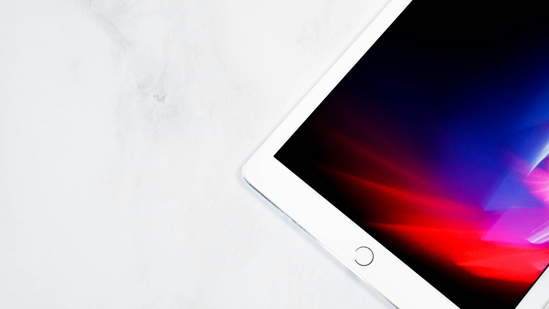 An iPad on a white surface | Source: Unsplash