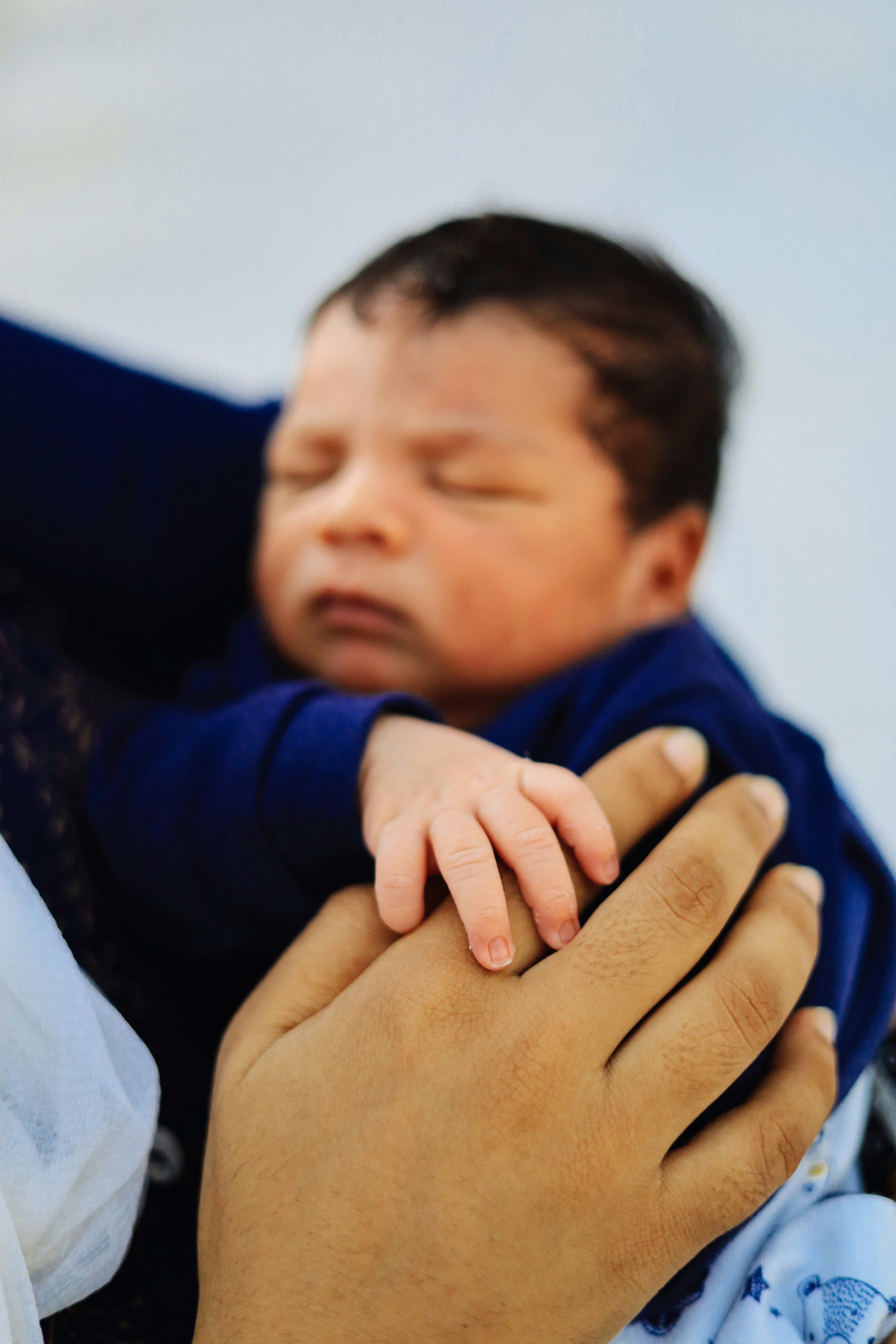 A woman holding a newborn baby boy | Source: Unsplash
