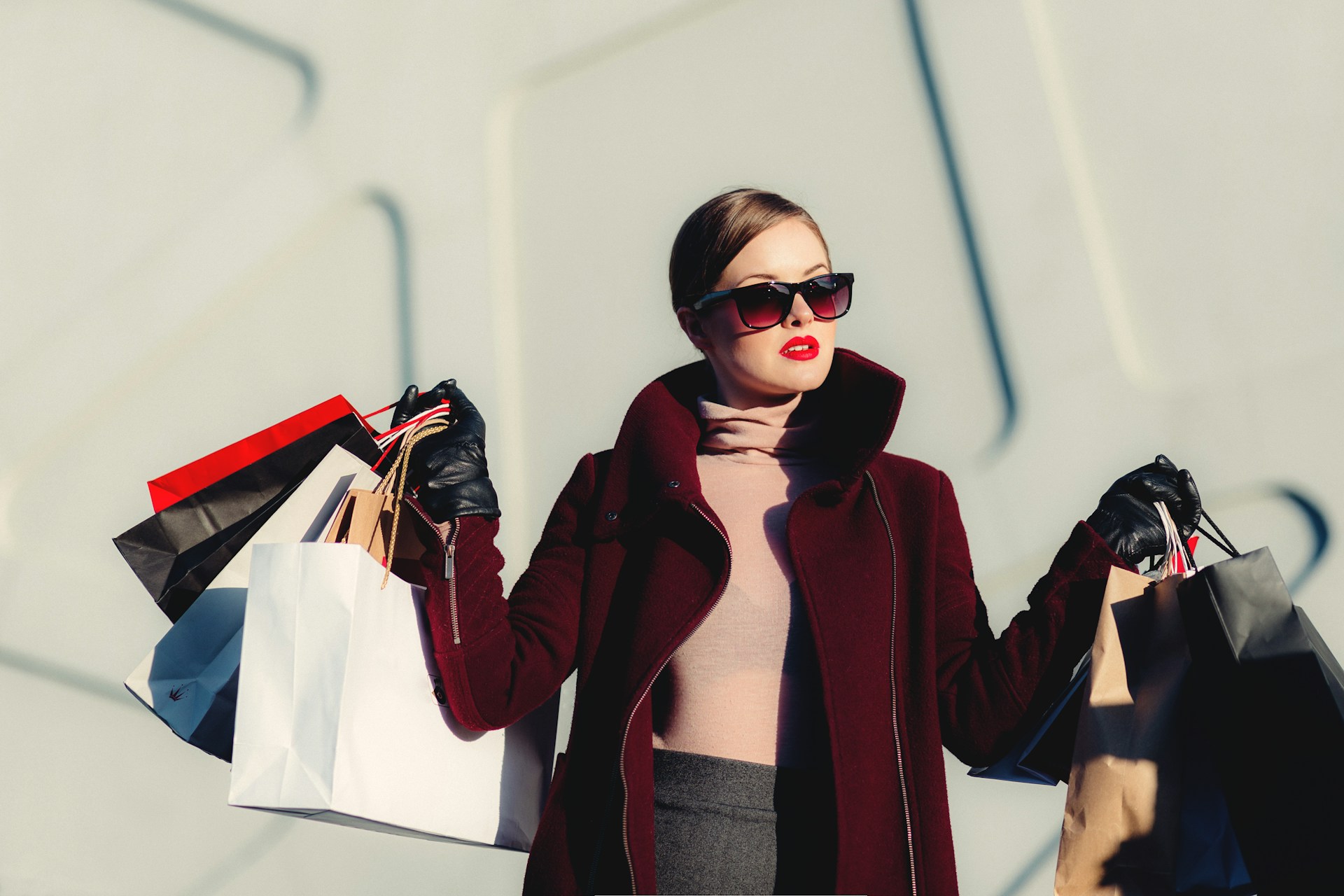 A rich woman holding shopping bags | Source: Unsplash