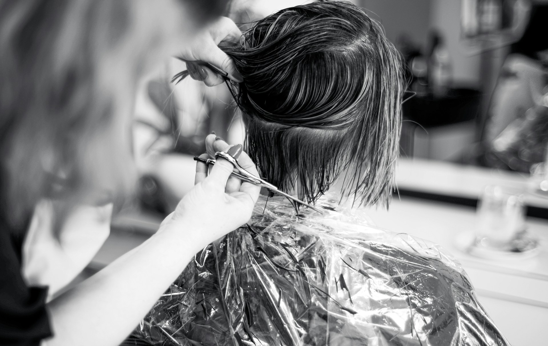 A female hairdresser styling a client's hair in the salon | Source: Unsplash
