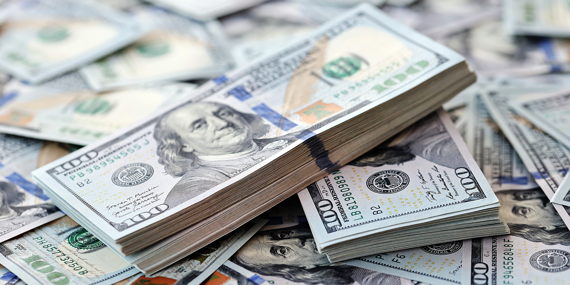 Close-up shot of hundred dollar bills | Source: Shutterstock
