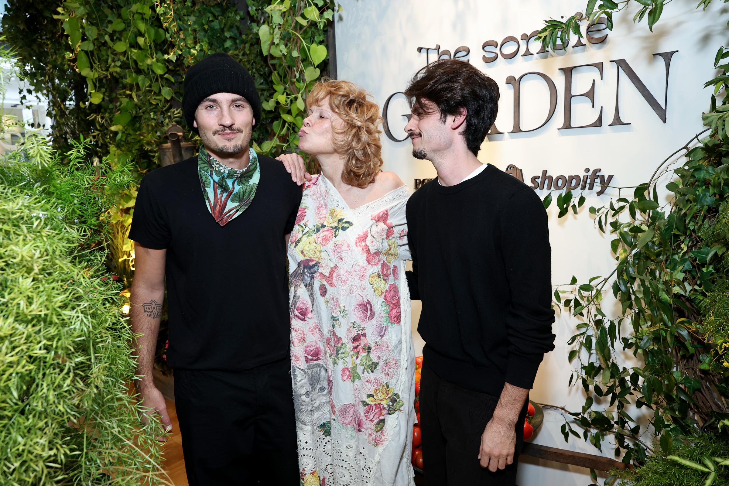 Pamela Anderson poses with her sons Brandon Thomas Lee and Dylan Jagger Lee at an event in Los Angeles, California. Brandon, on the left, wears a black T-shirt and beanie, while Dylan, on the right, wears a black sweater. | Source: Getty Images
