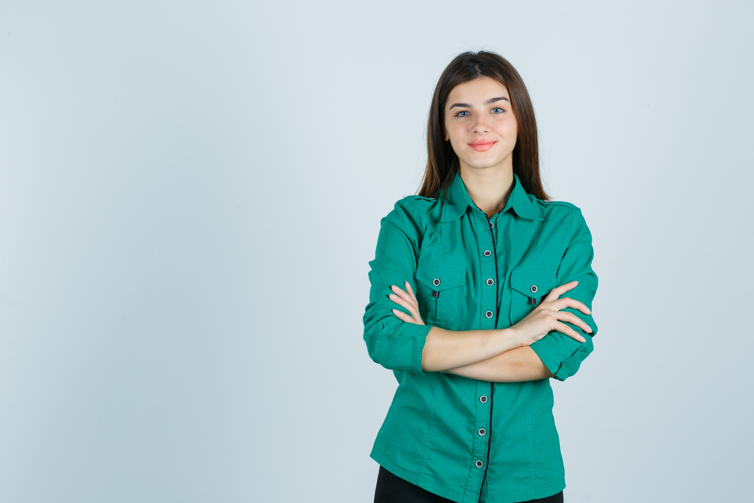 A smiling woman with her arms crossed | Source: Freepik