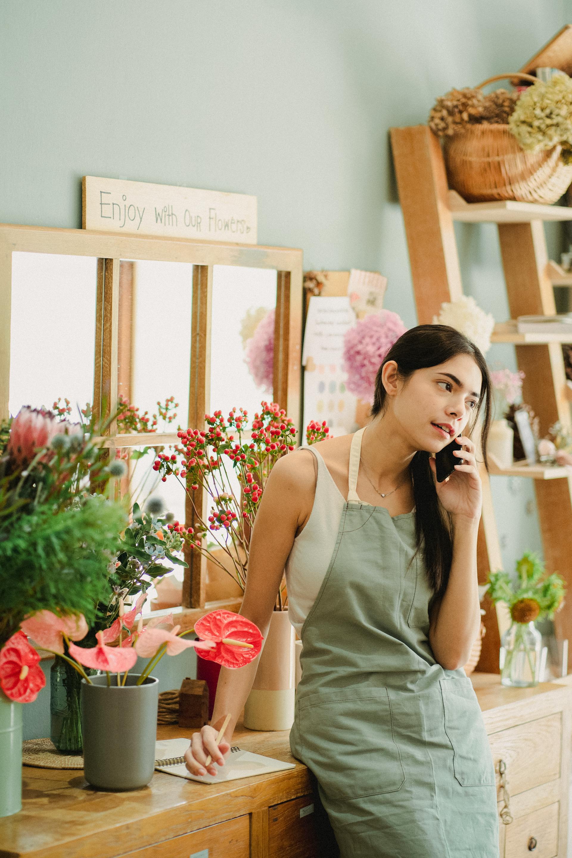 A florist speaking on a phone | Source: Pexels