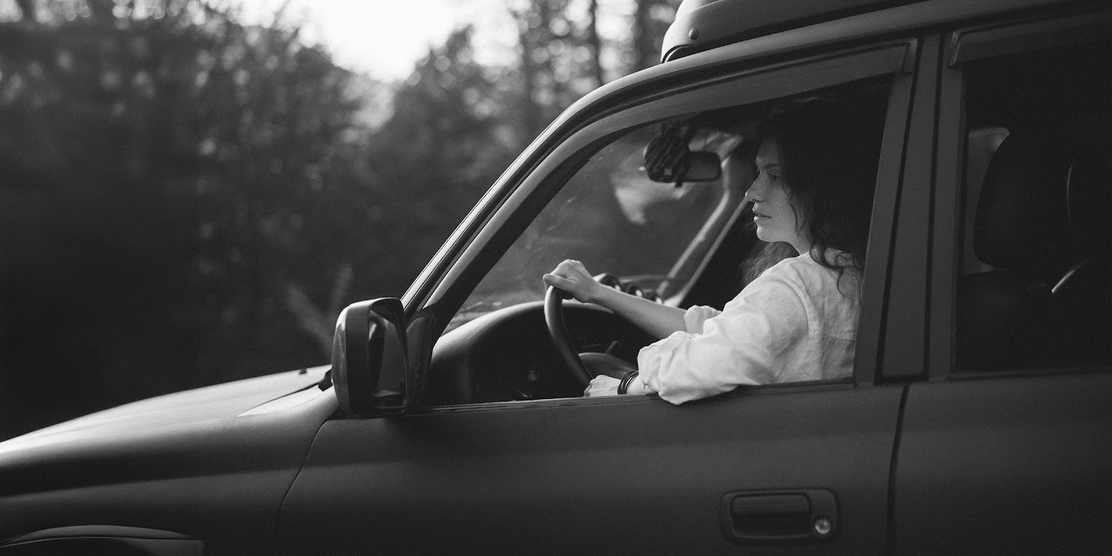 A woman in a car | Source: Midjourney