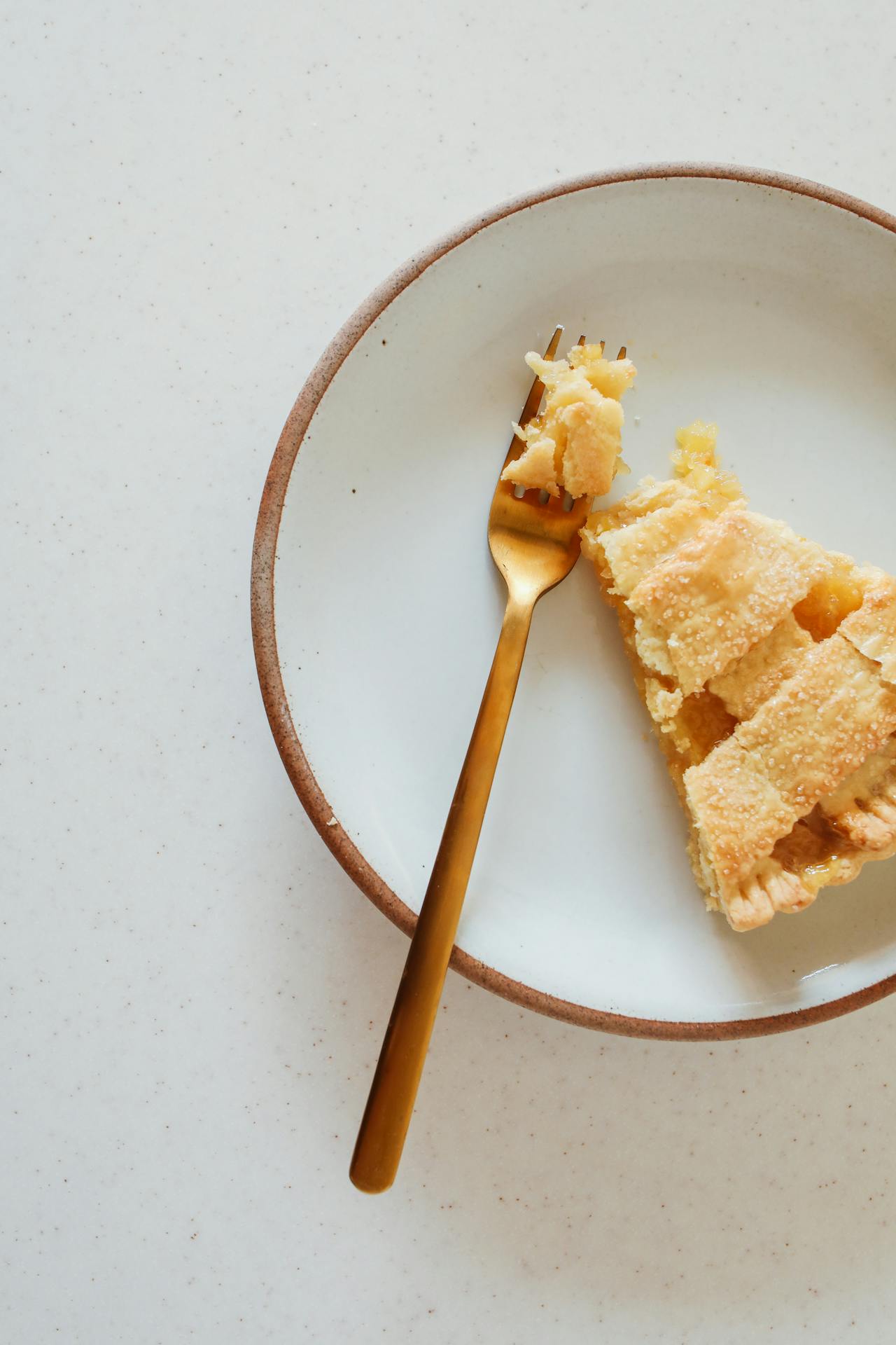 A slice of lemon pie on a plate | Source: Pexels