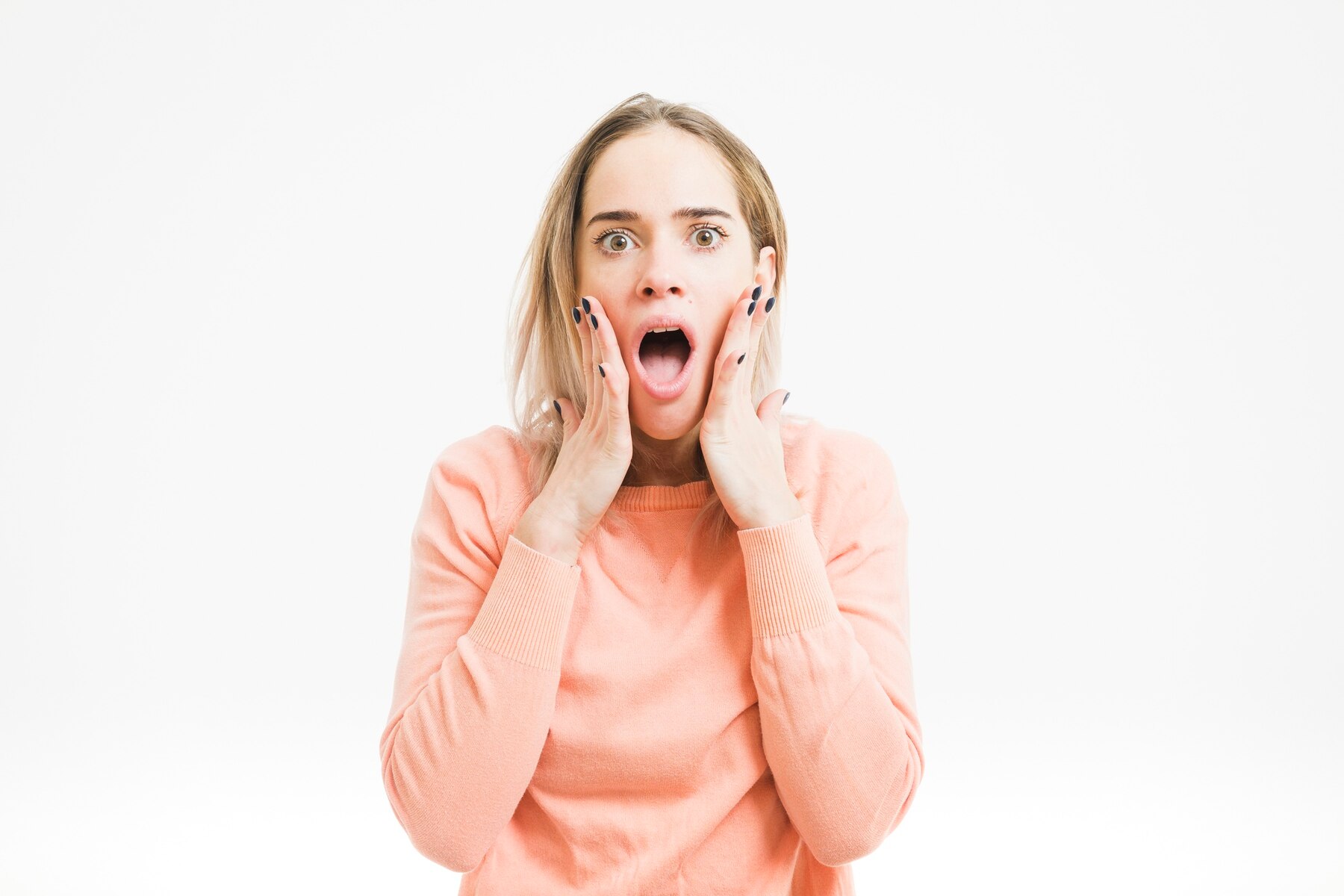 A shocked blonde woman | Source: Freepik